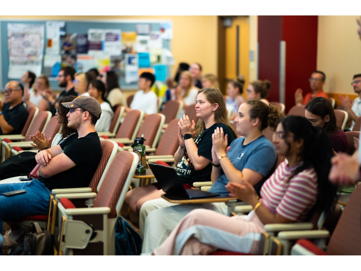 A group of second-year doctoral students clap after a presentation during the 2024-2025 neuroscience seminar series.