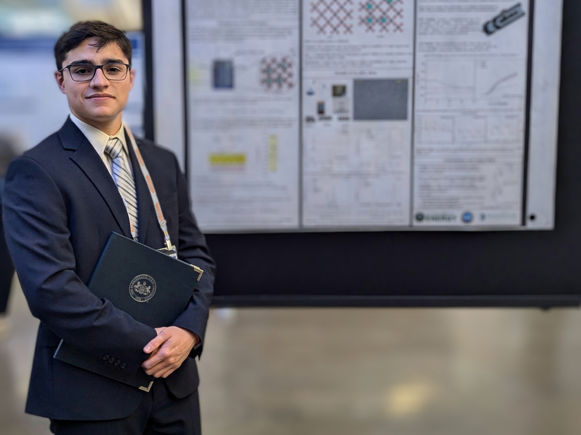 Penn State student and Millennium Scholar Matias Moreno stands next to poster displaying research