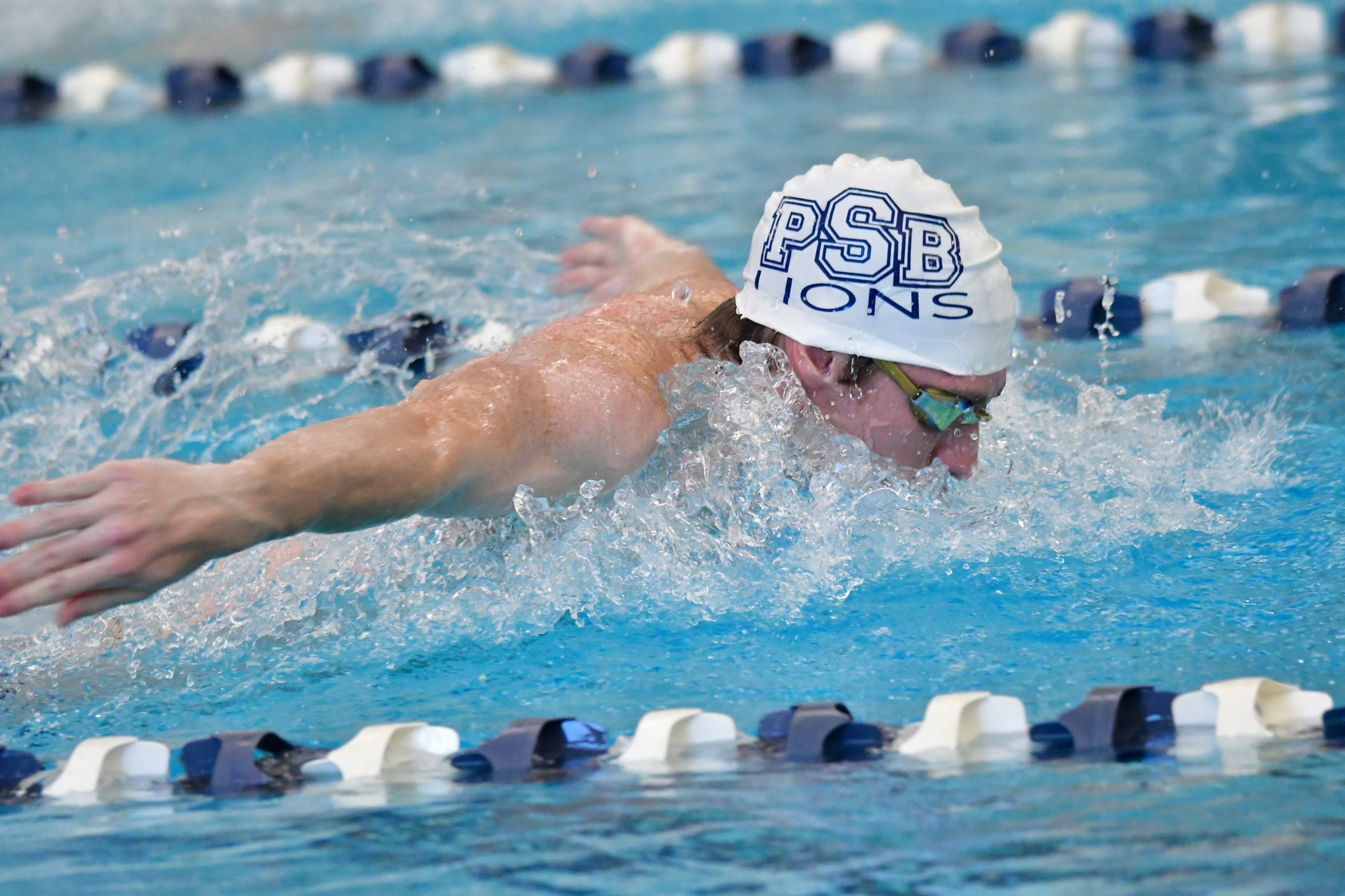 A Penn State Behrend swimmer competes in a butterfly event.