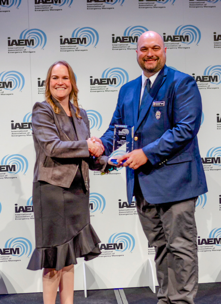 William A. Schlosser receives an award from Carrie Speranza