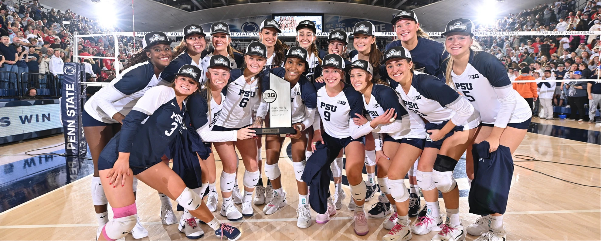 Women's volleyball team poses with Big Ten trophy