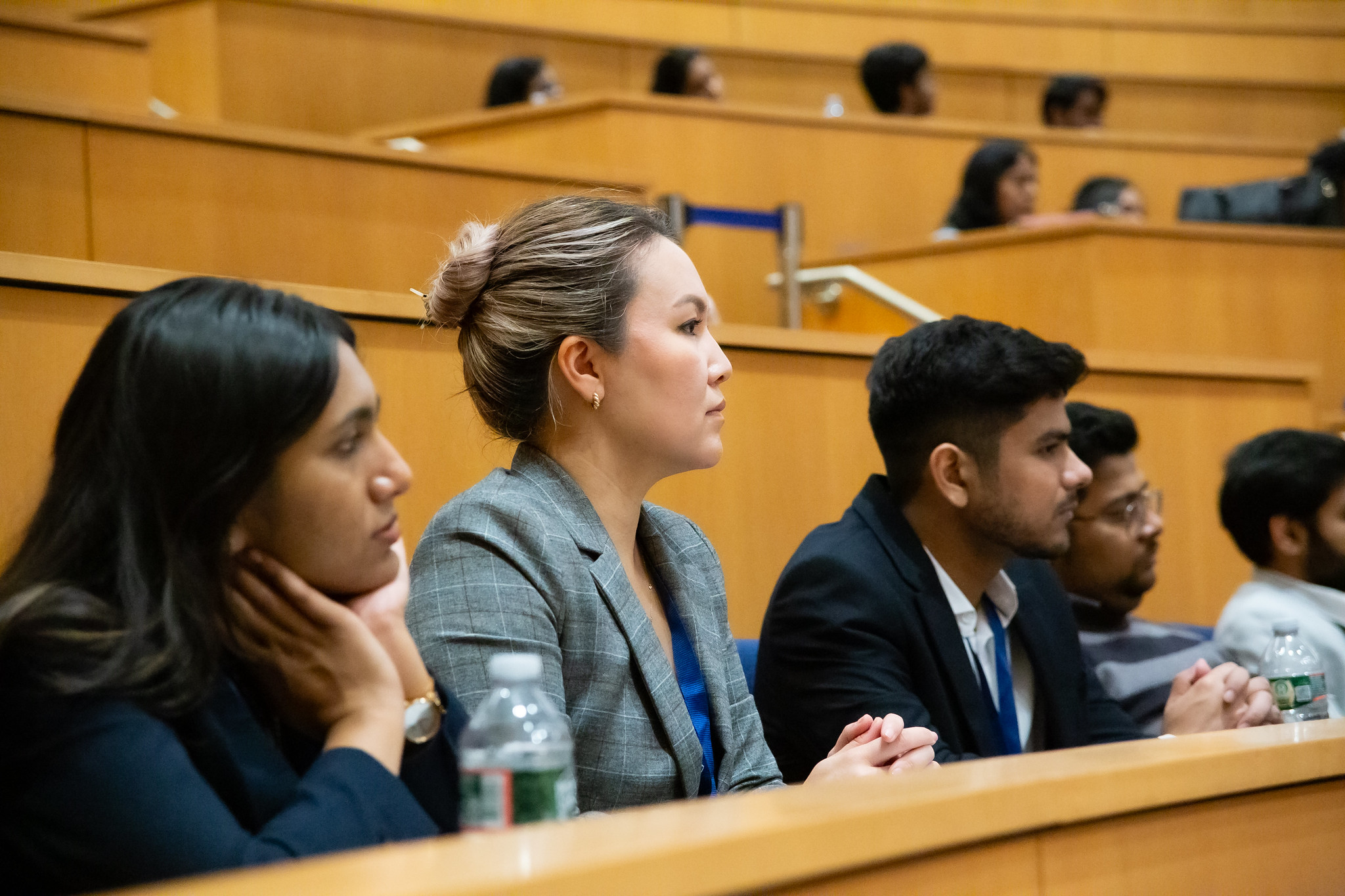 Three students watching a lecture