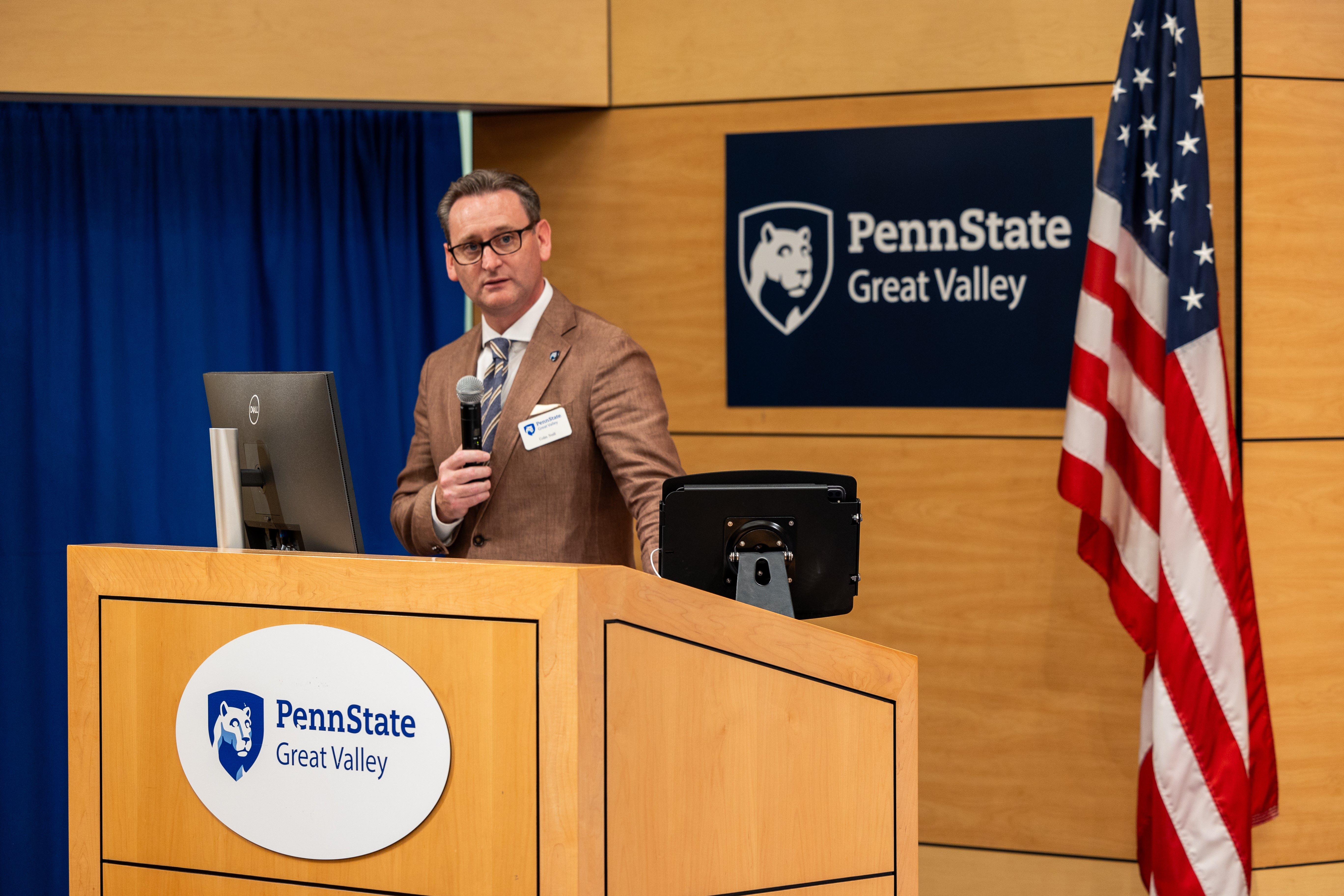 Professor and chancellor Colin J. Neill speaks at a podium at Penn State Great Valley