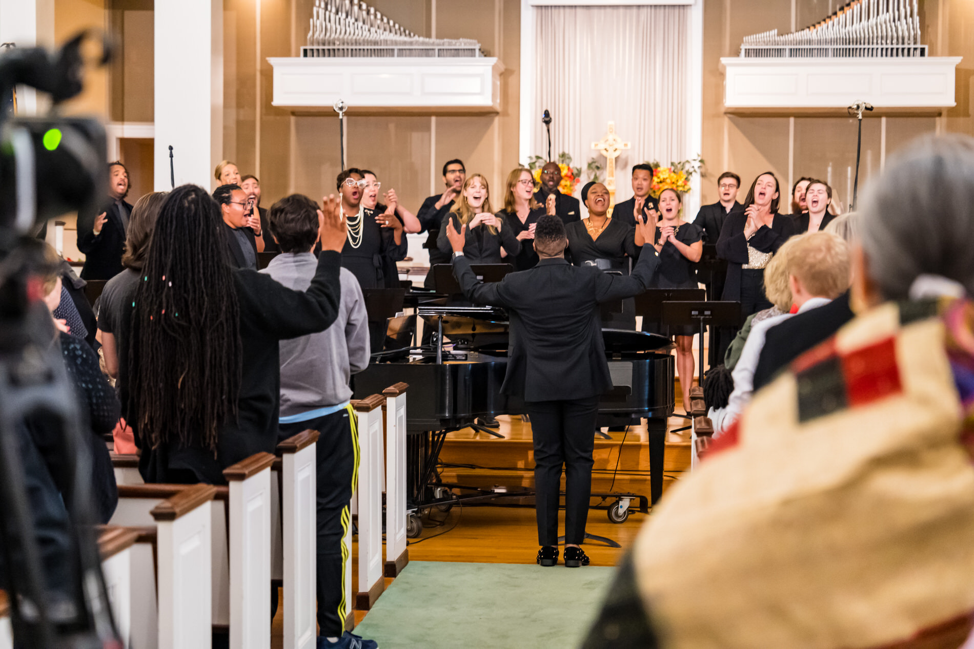 A diverse chorus performs in a church.