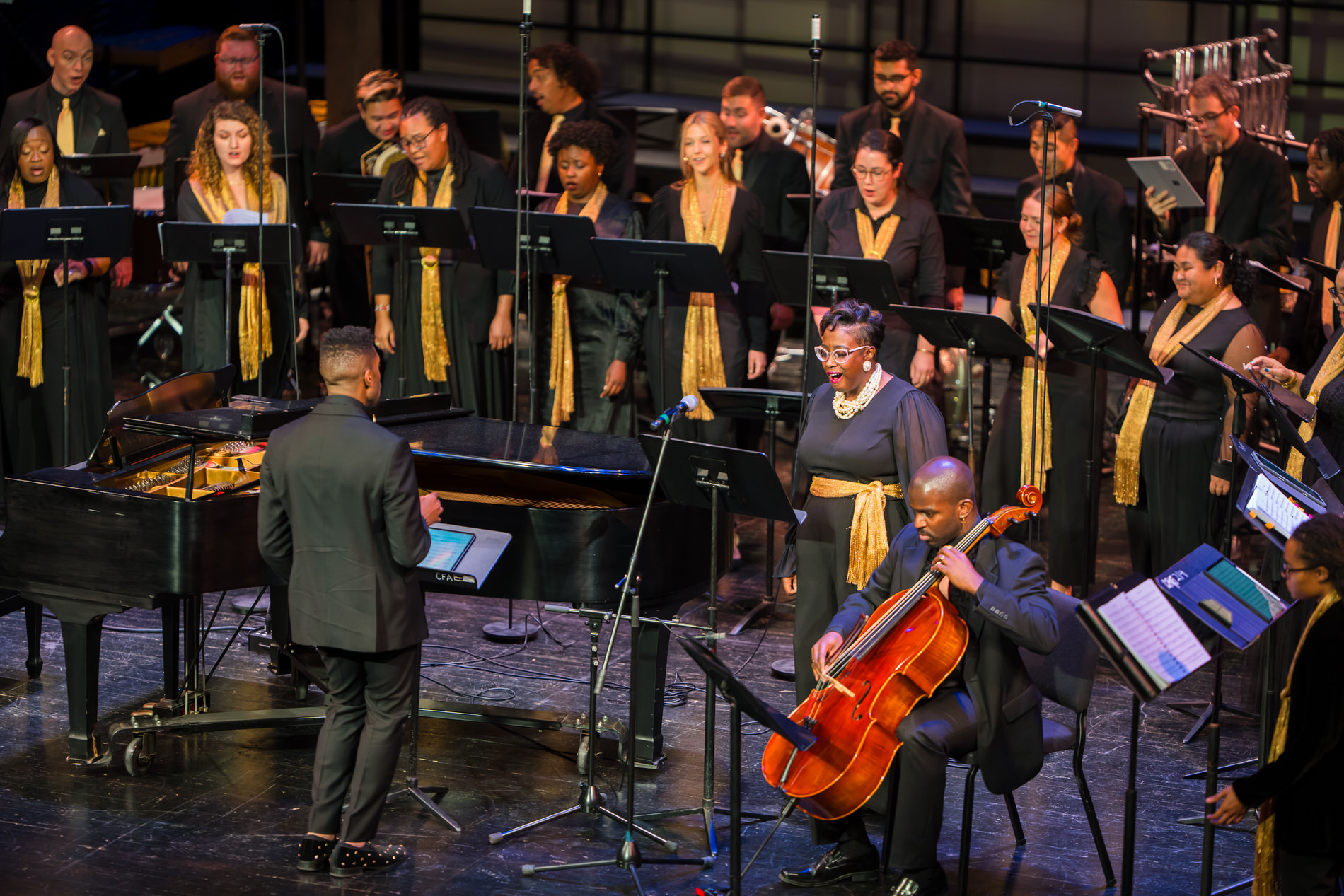 A diverse choir performs on a stage.