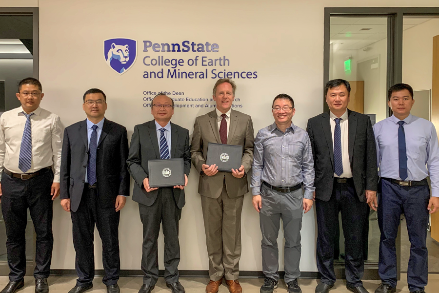 A delegation from The Shandong University of Science and Technology and Penn State counterparts holding signed memorandum of understanding.