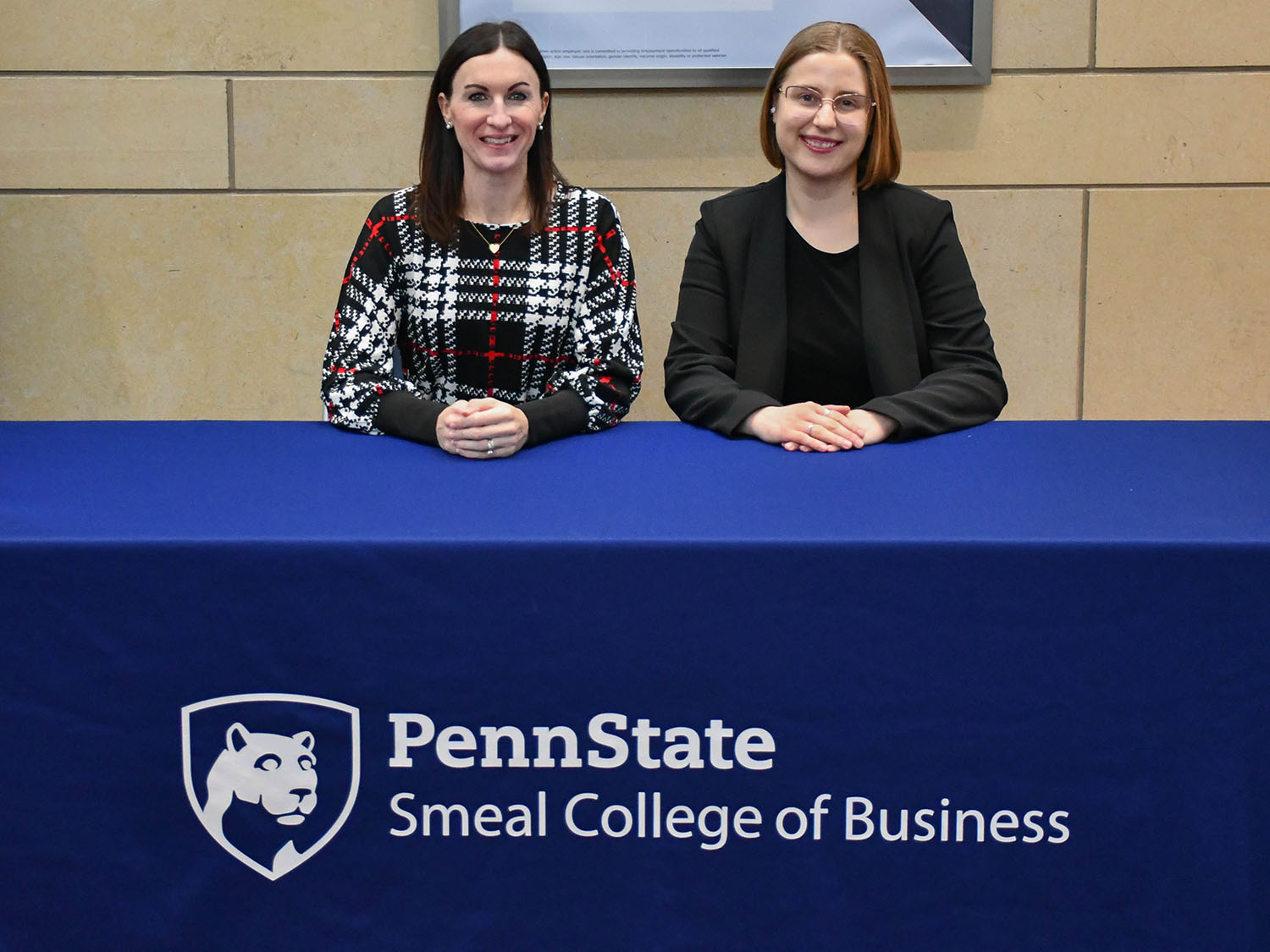 A photo of Ashley Rippey and Alexandra Stossel sitting at a table