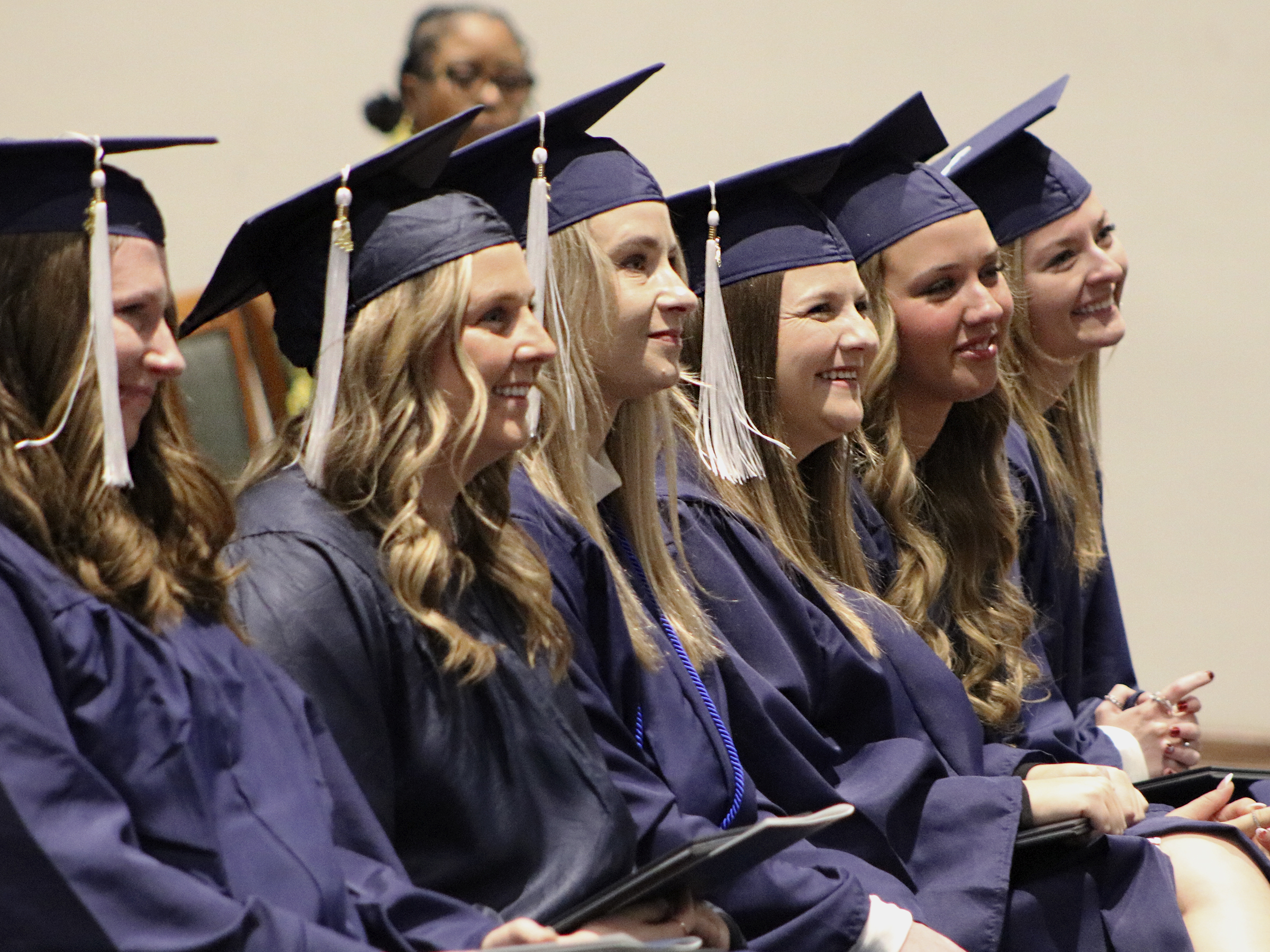 Graduates wearing caps and gowns smiling