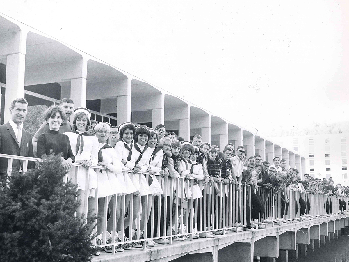 Students, faculty, and staff pose for a photo on the portico of the Slep Student Center in a photo taken in the 1970s.