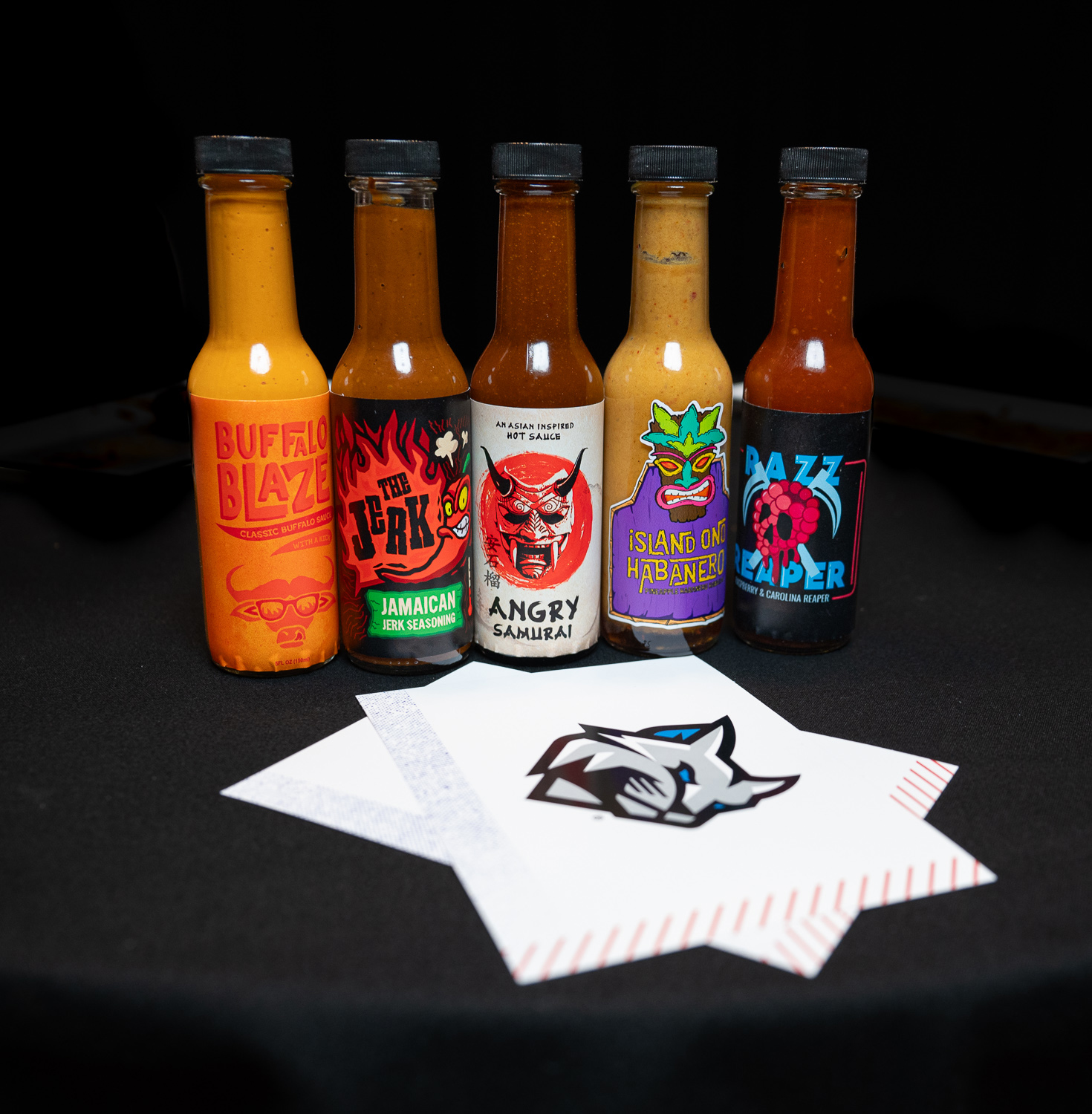 Several bottles of hot sauce on a table