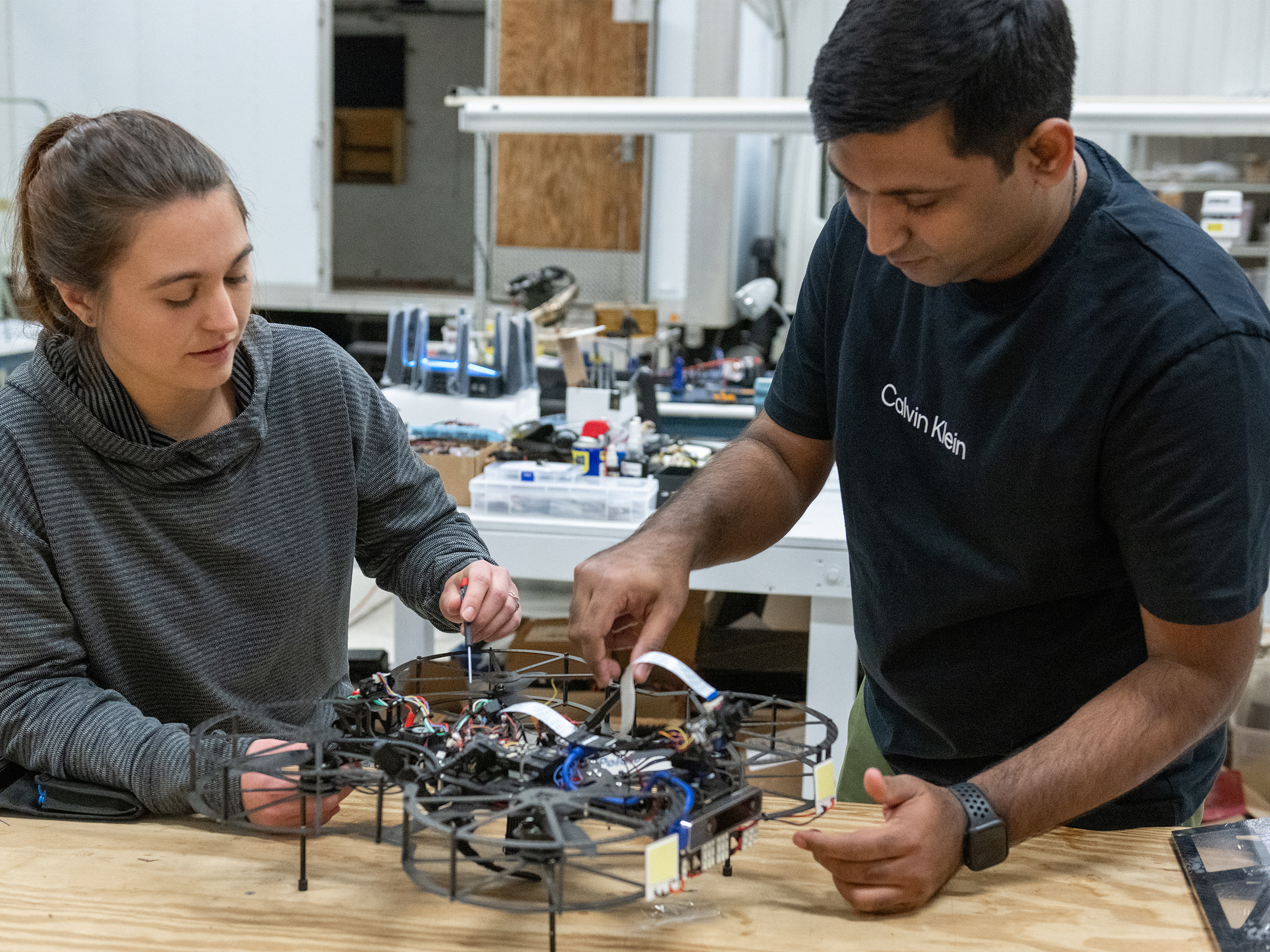 Two researchers working on drone