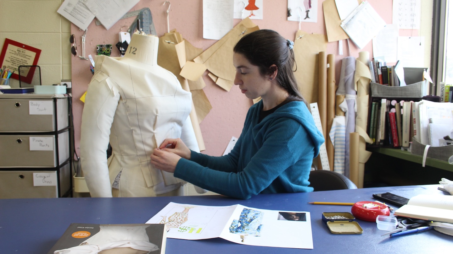 A woman working on a costume