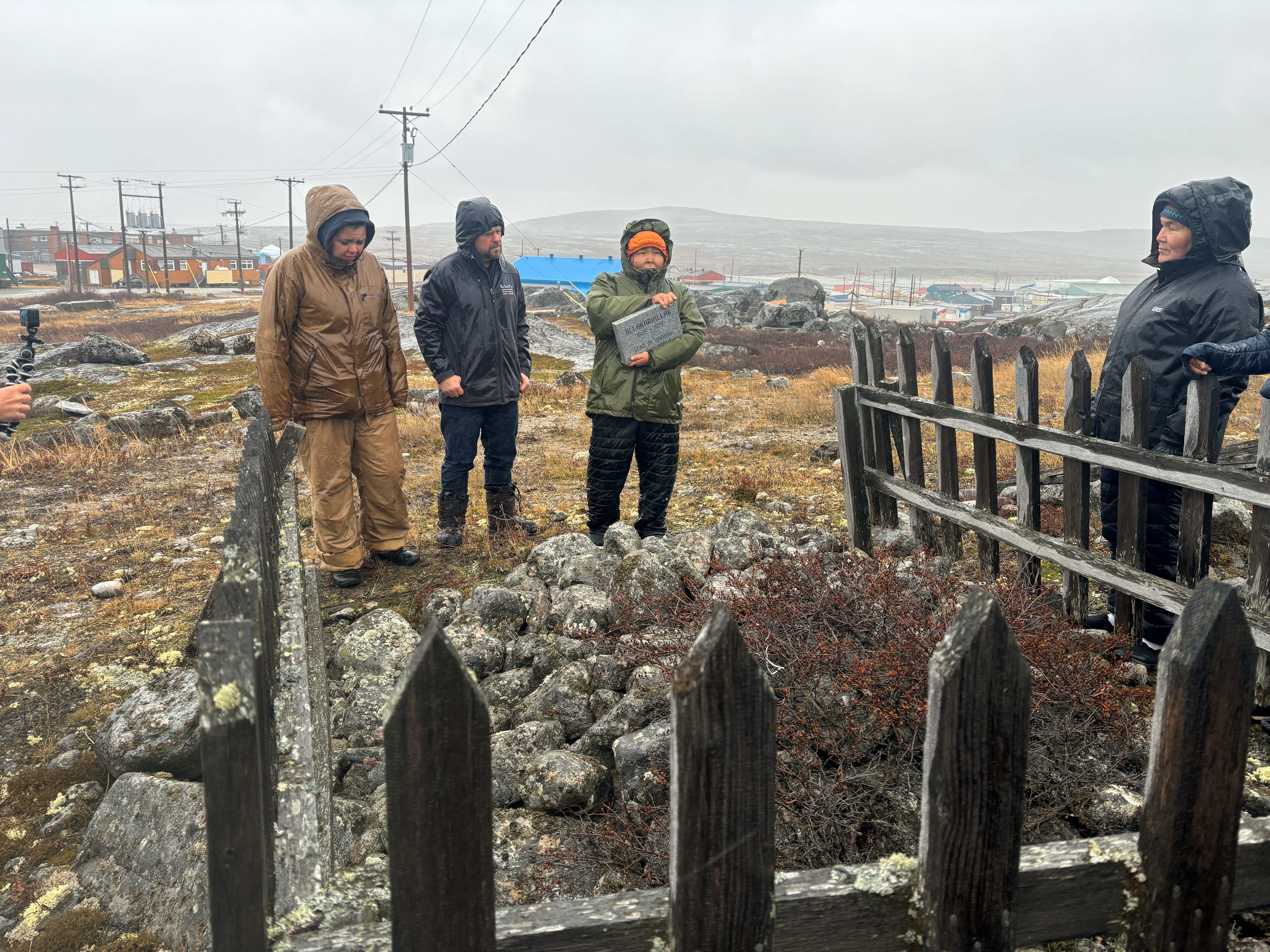 People gather at a burial site. 