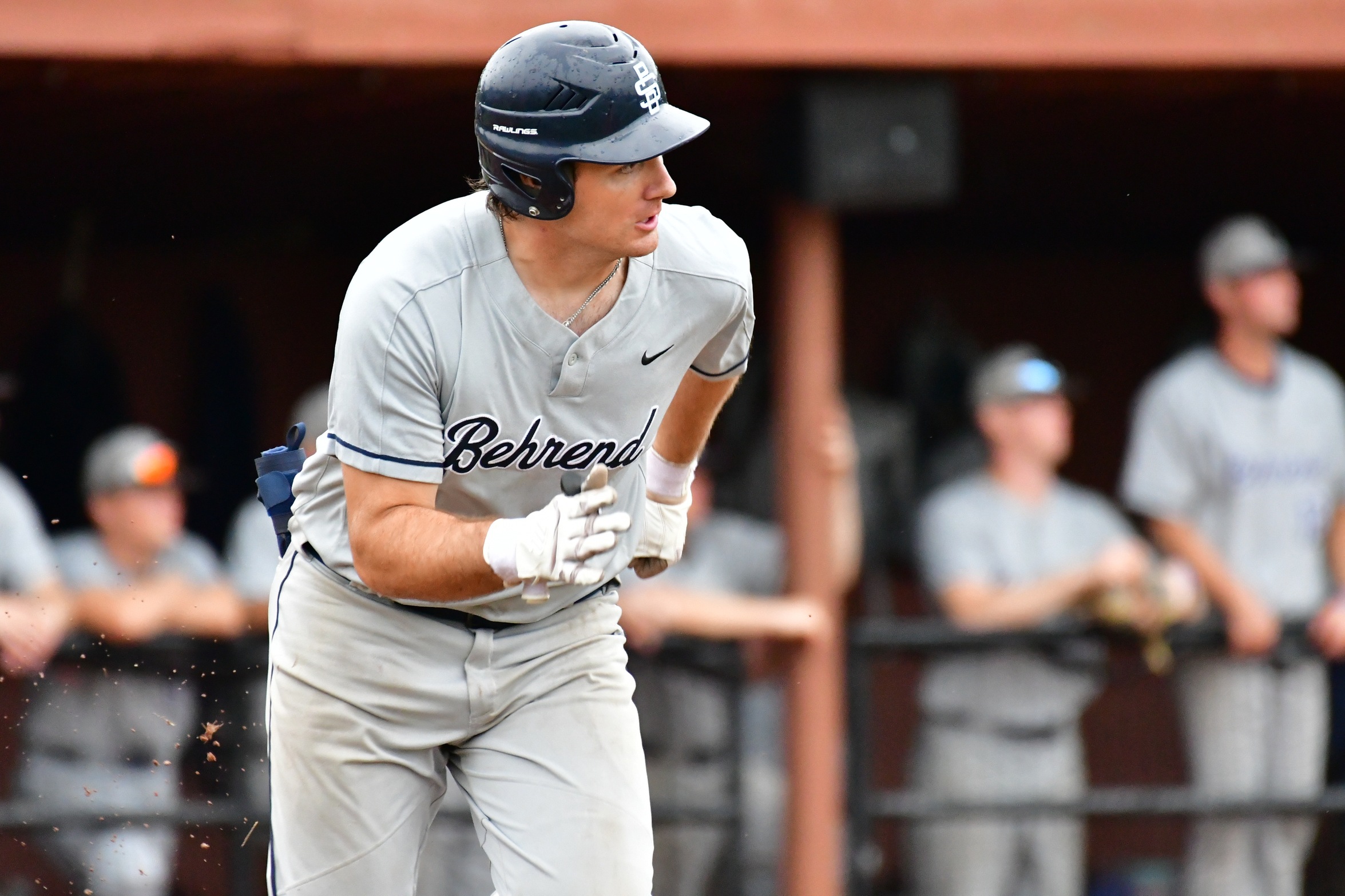 A Penn State Behrend baseball player runs to first base.