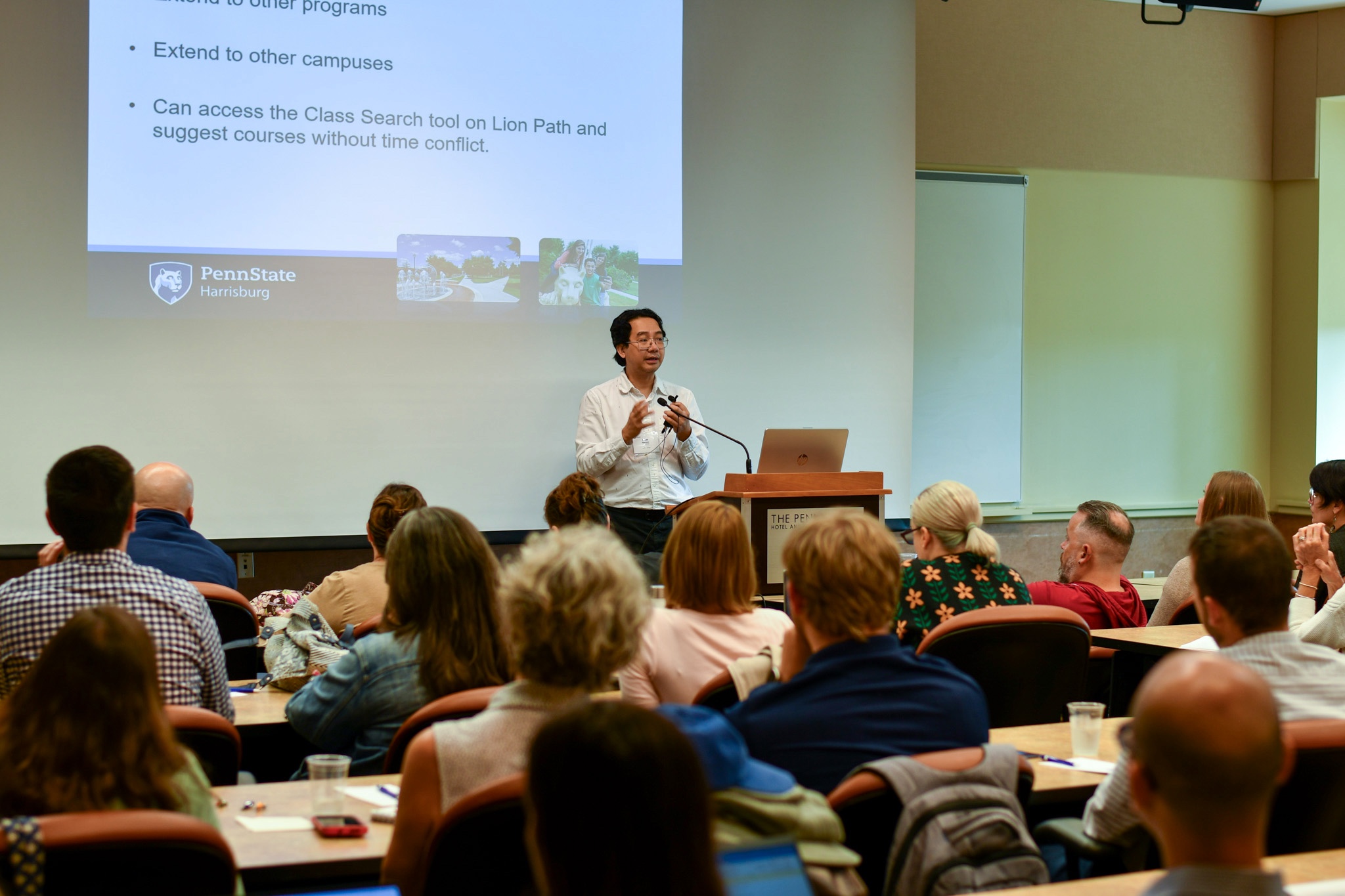 Speaker presenting in front of seated audience