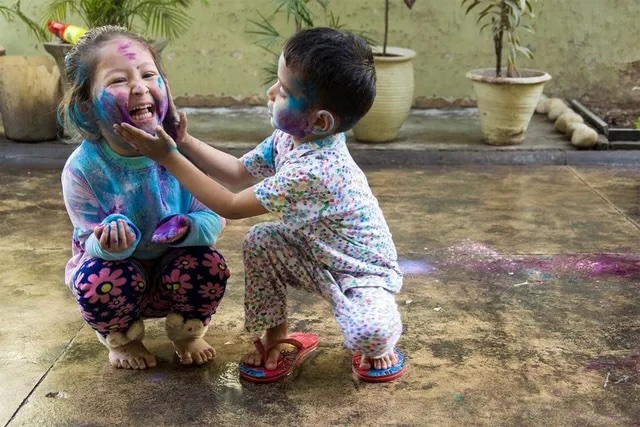Two toddlers playing together with chalk