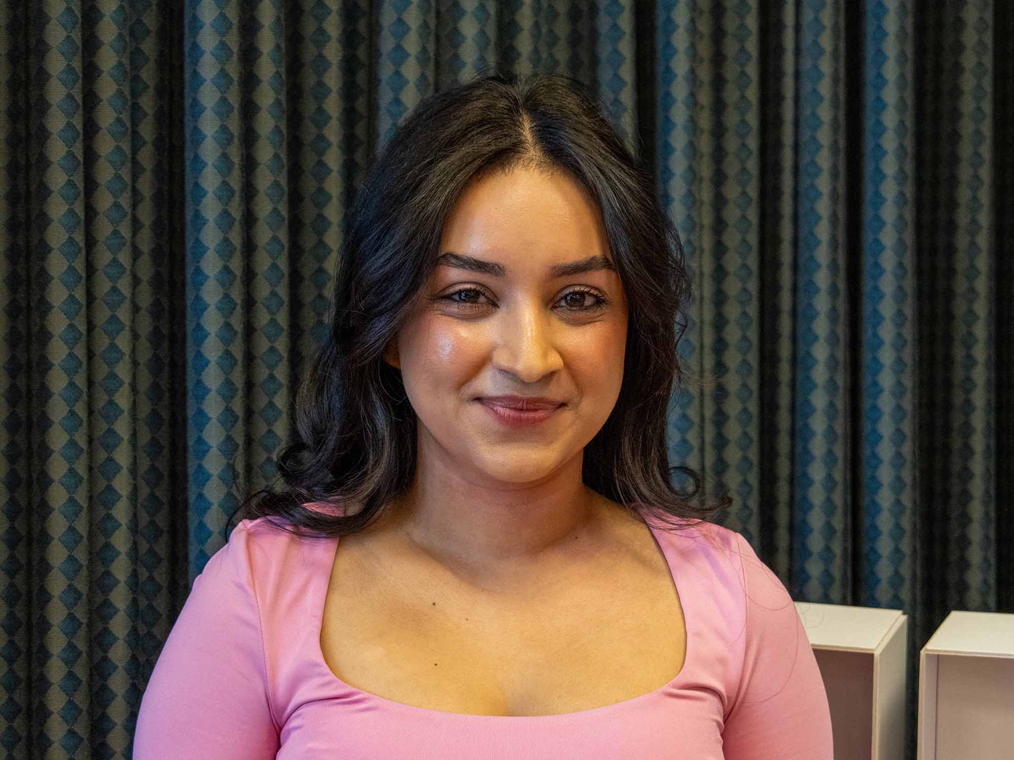 Tapashya Ghimirey smiles on stage at Penn State Greater Allegheny.