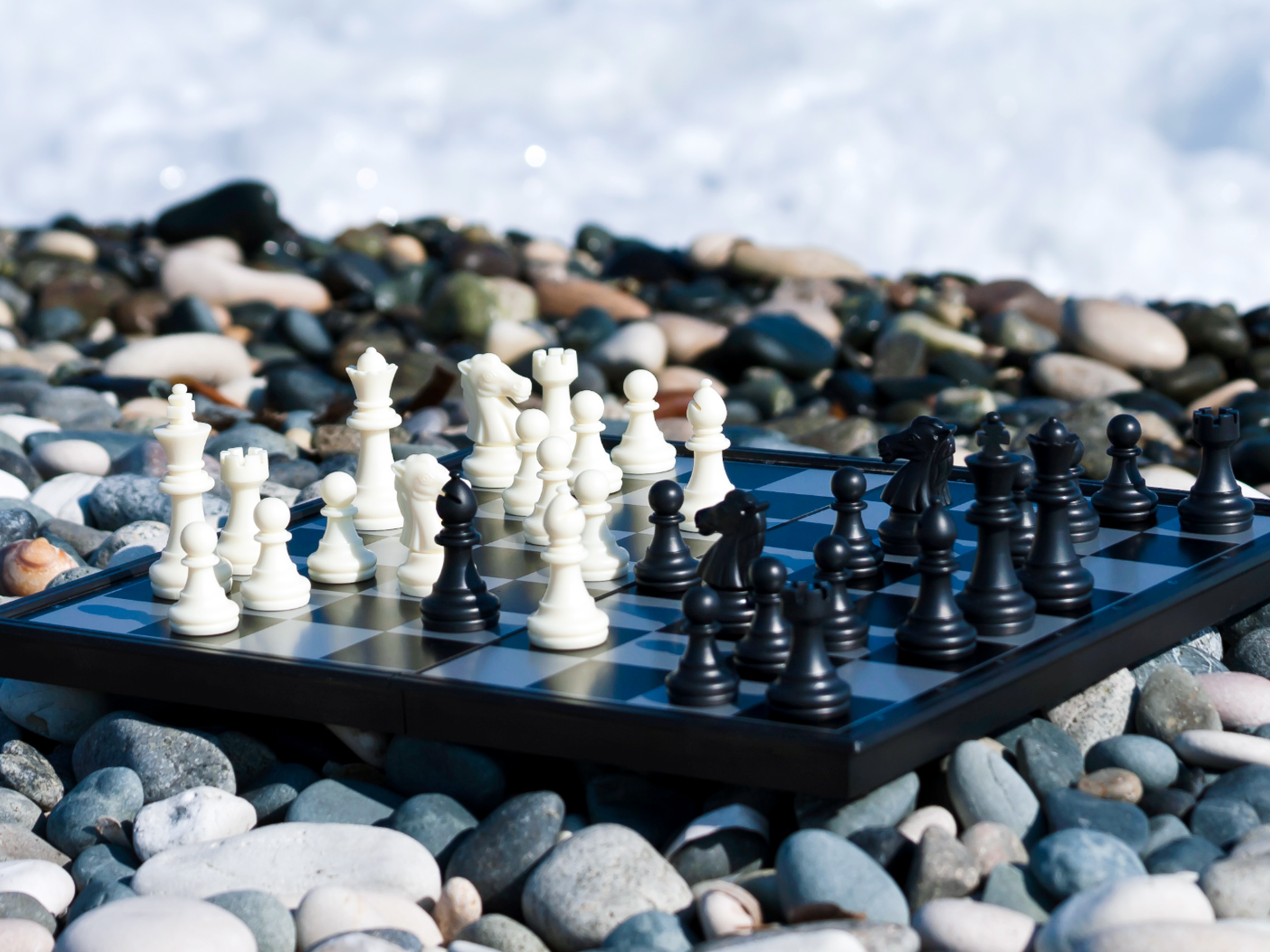 chess board on rocks near shore
