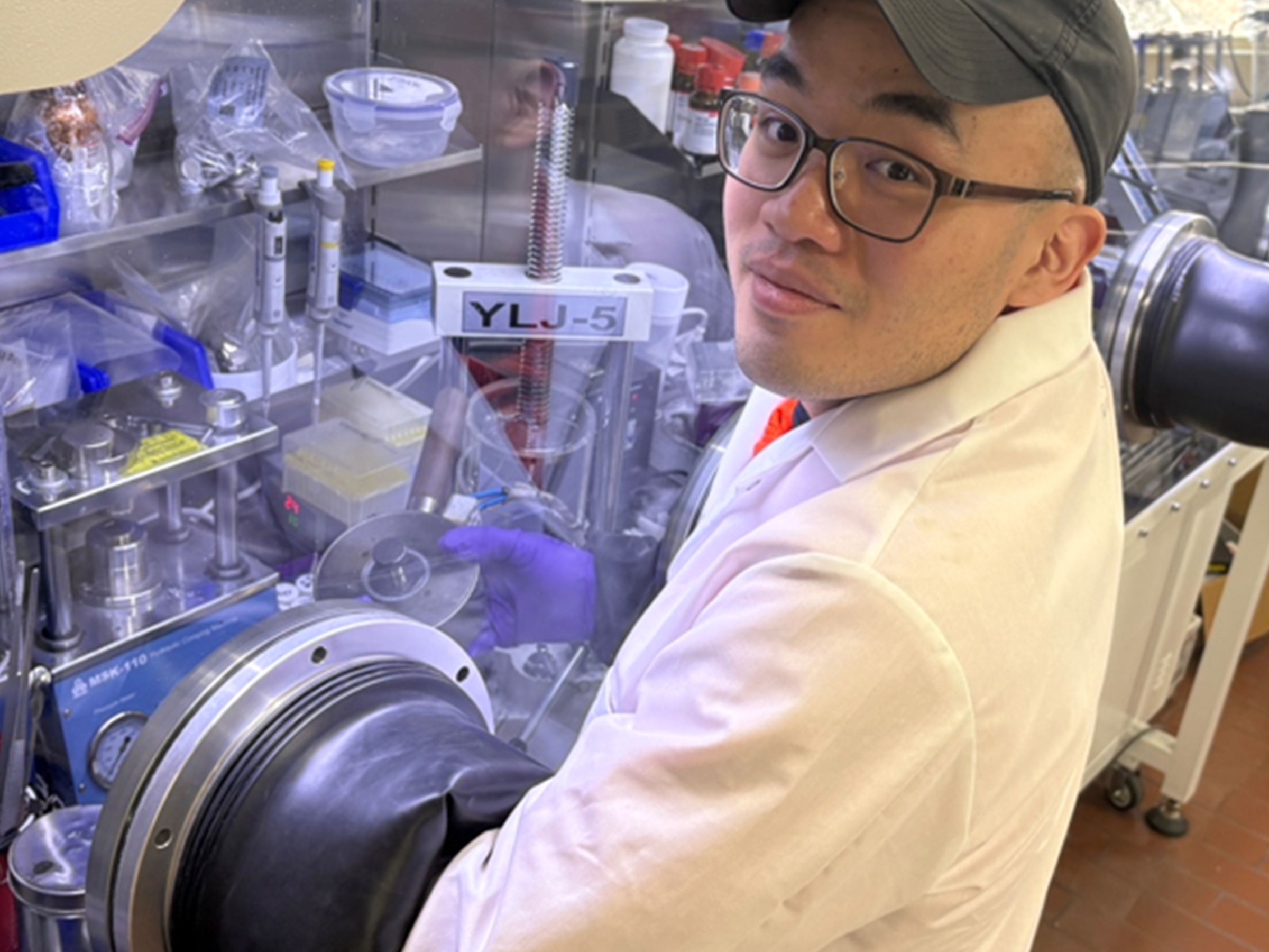 Person working in a lab with gloves in a chamber