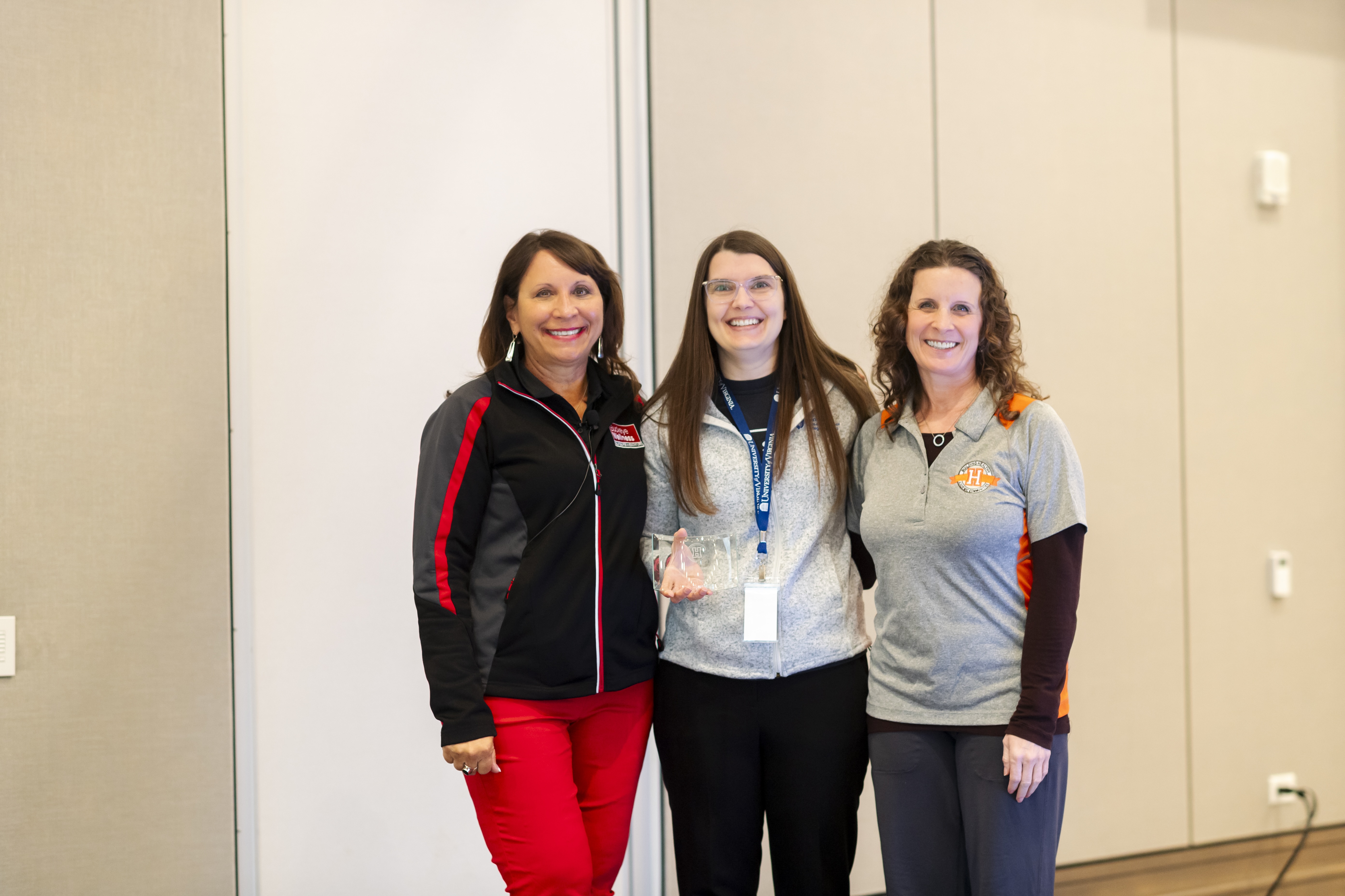 Christina Lightner, middle, receiving the 2025 BHAC Impact Award.