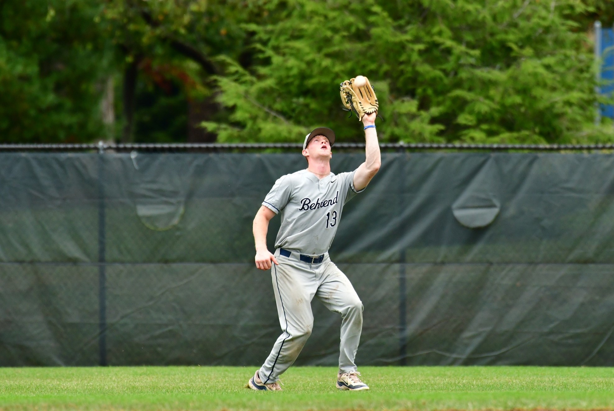 An outfielder catches the ball during a Penn State Behrend baseball game.