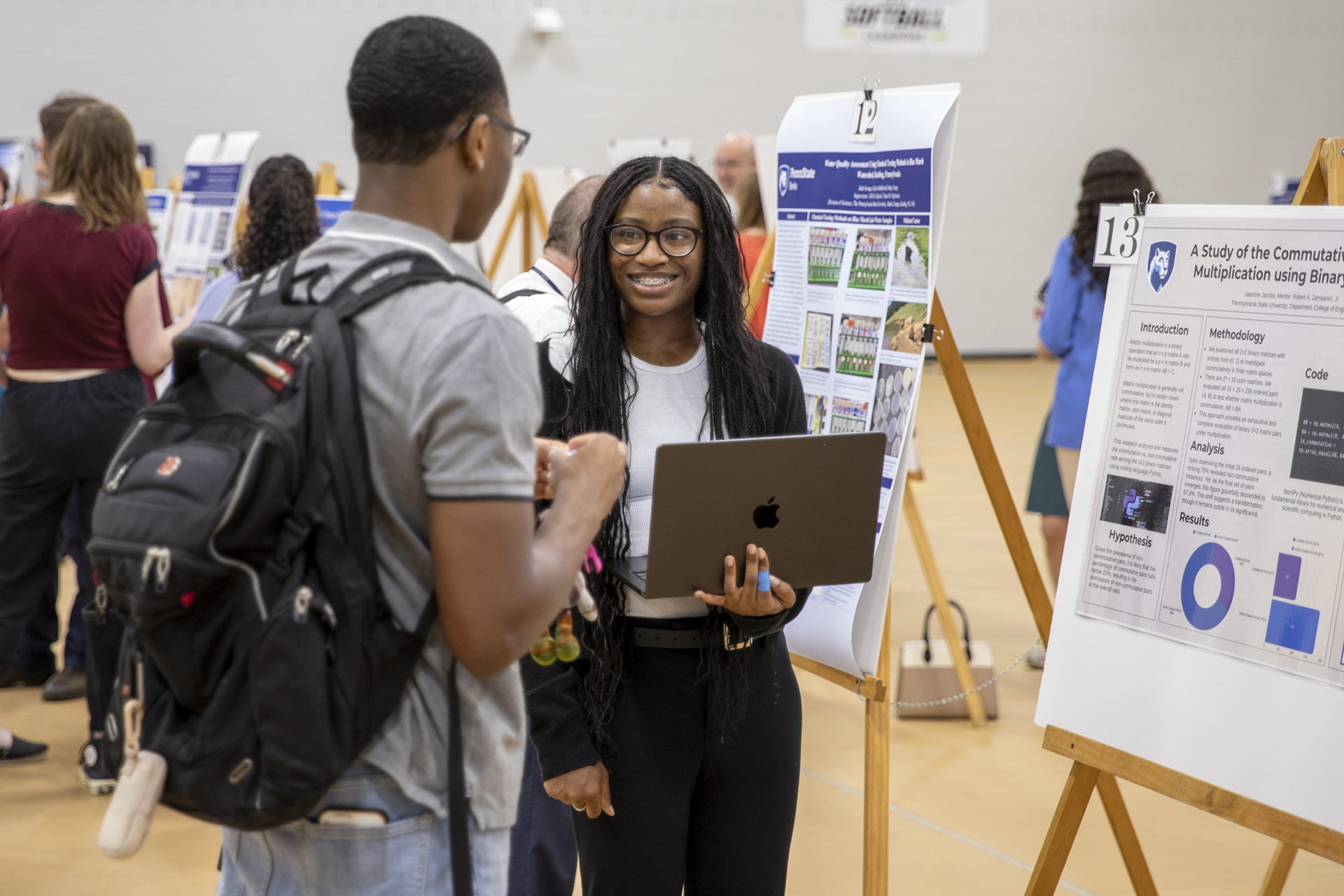 Students presenting research in poster session