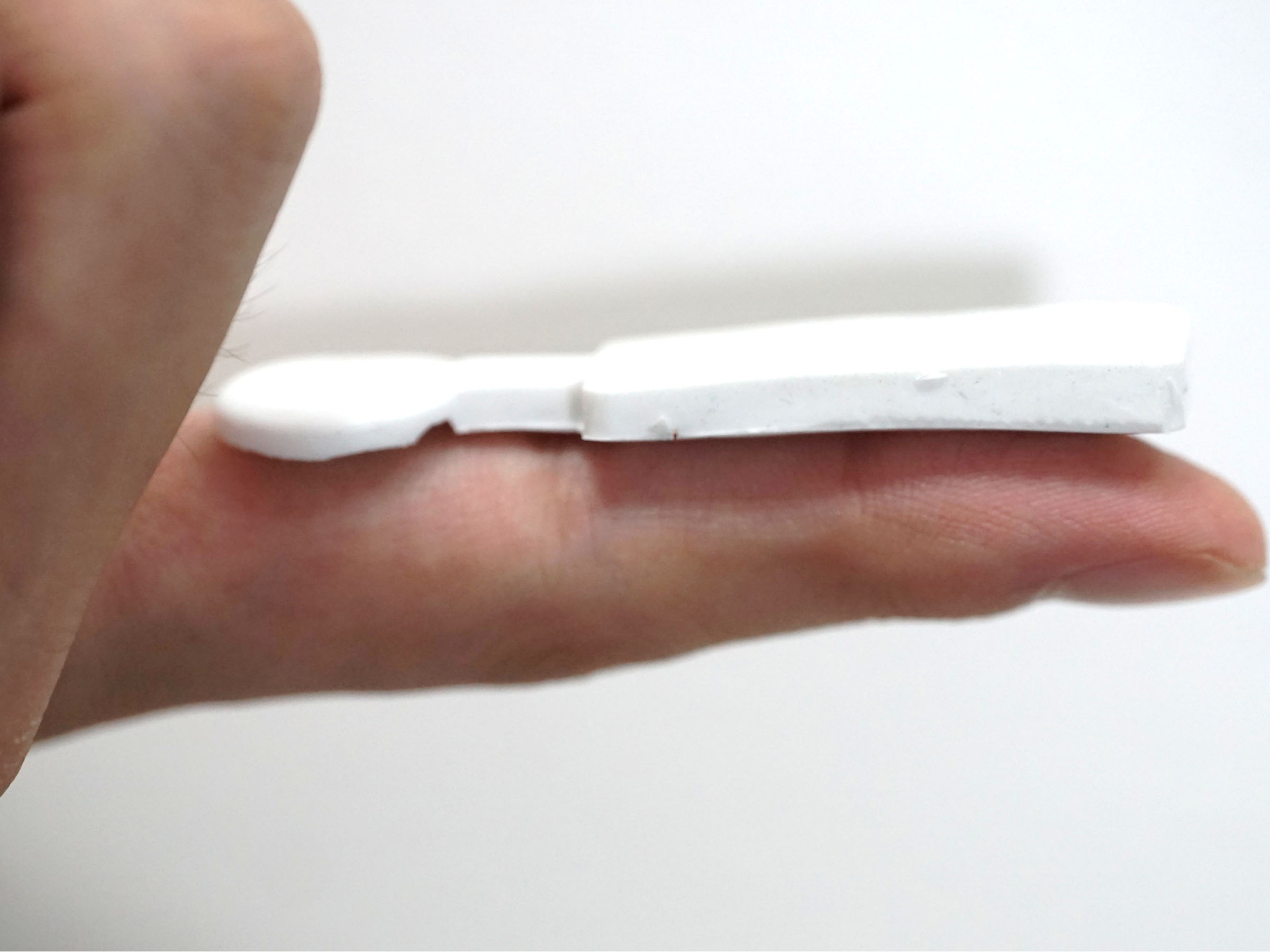 A sensor rests on an outstretched finger 