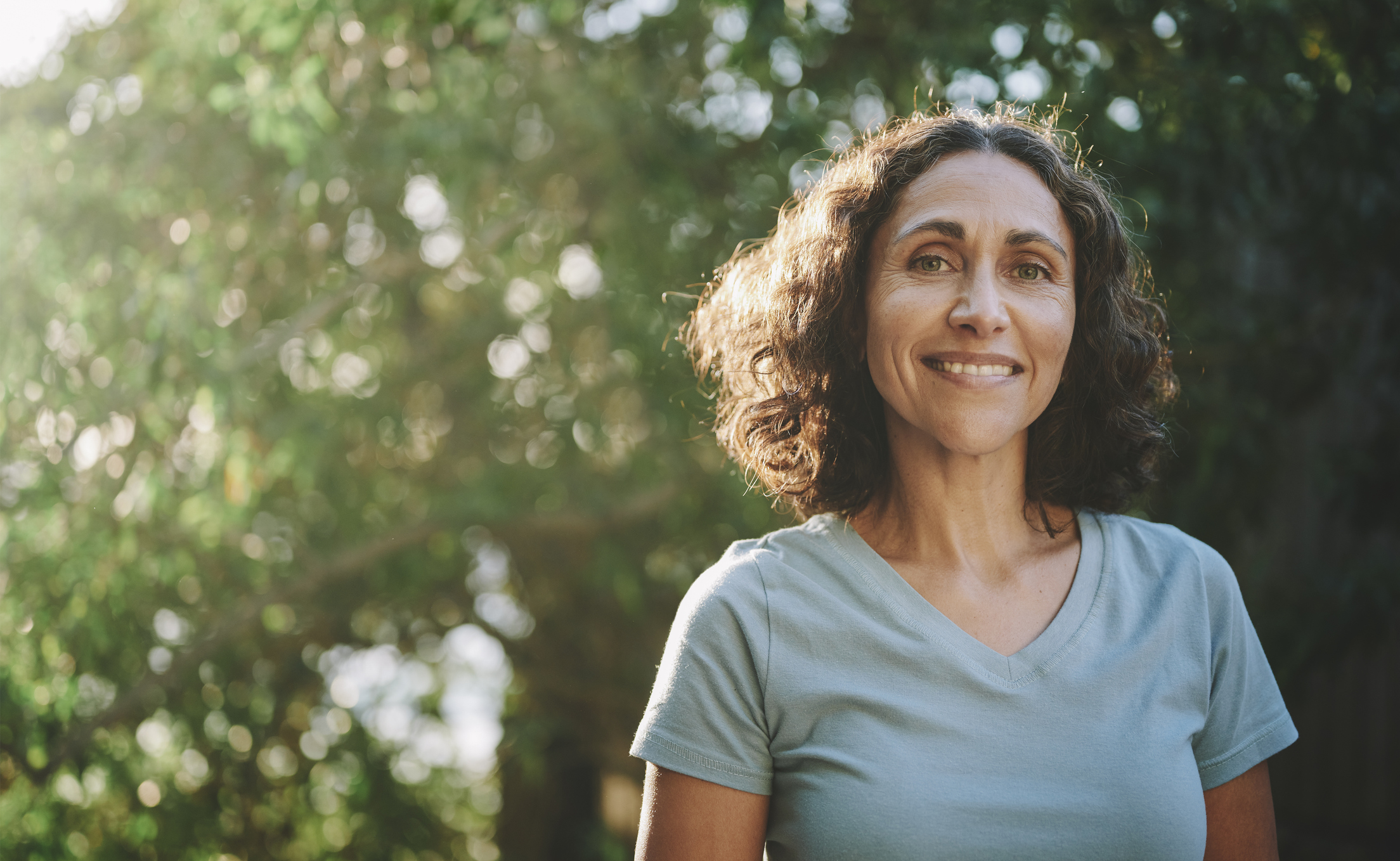 smiling woman outside in park