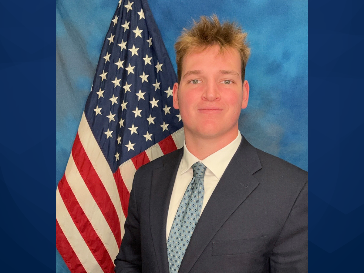 Portrait of Drew Gochnauer with a U.S. flag