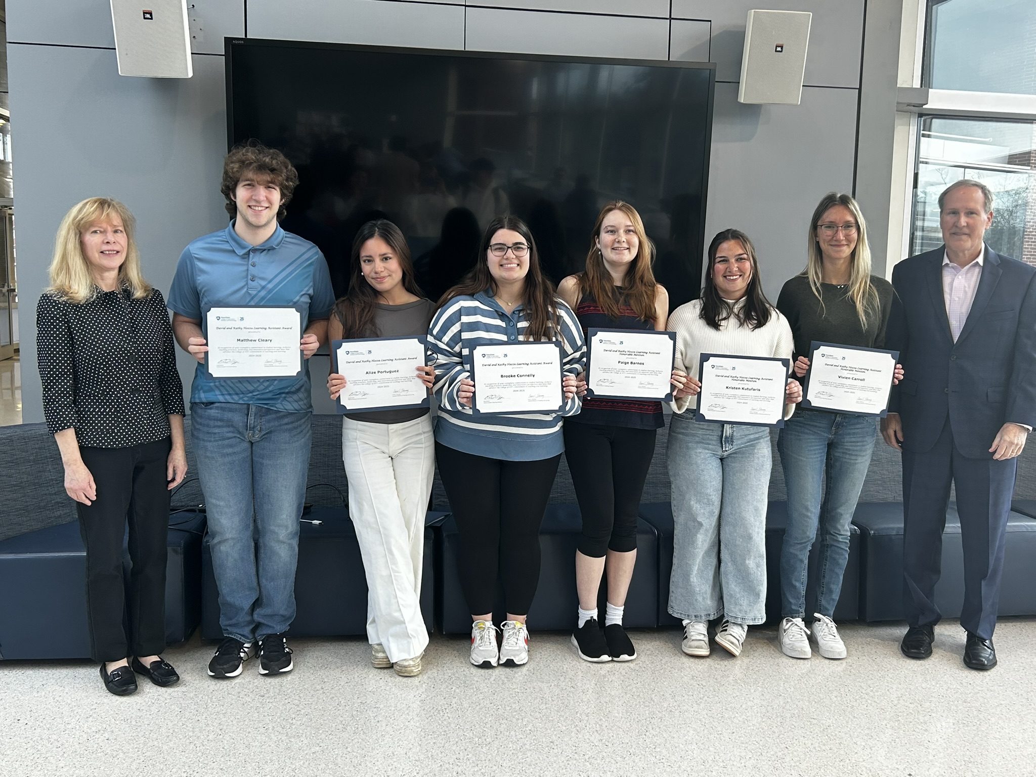 Students posing with award certificates