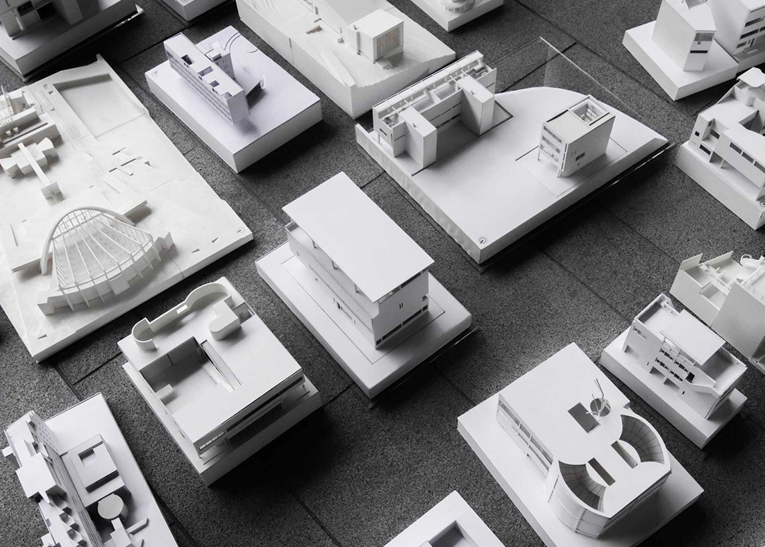 A black and white photograph of several architectural models. 