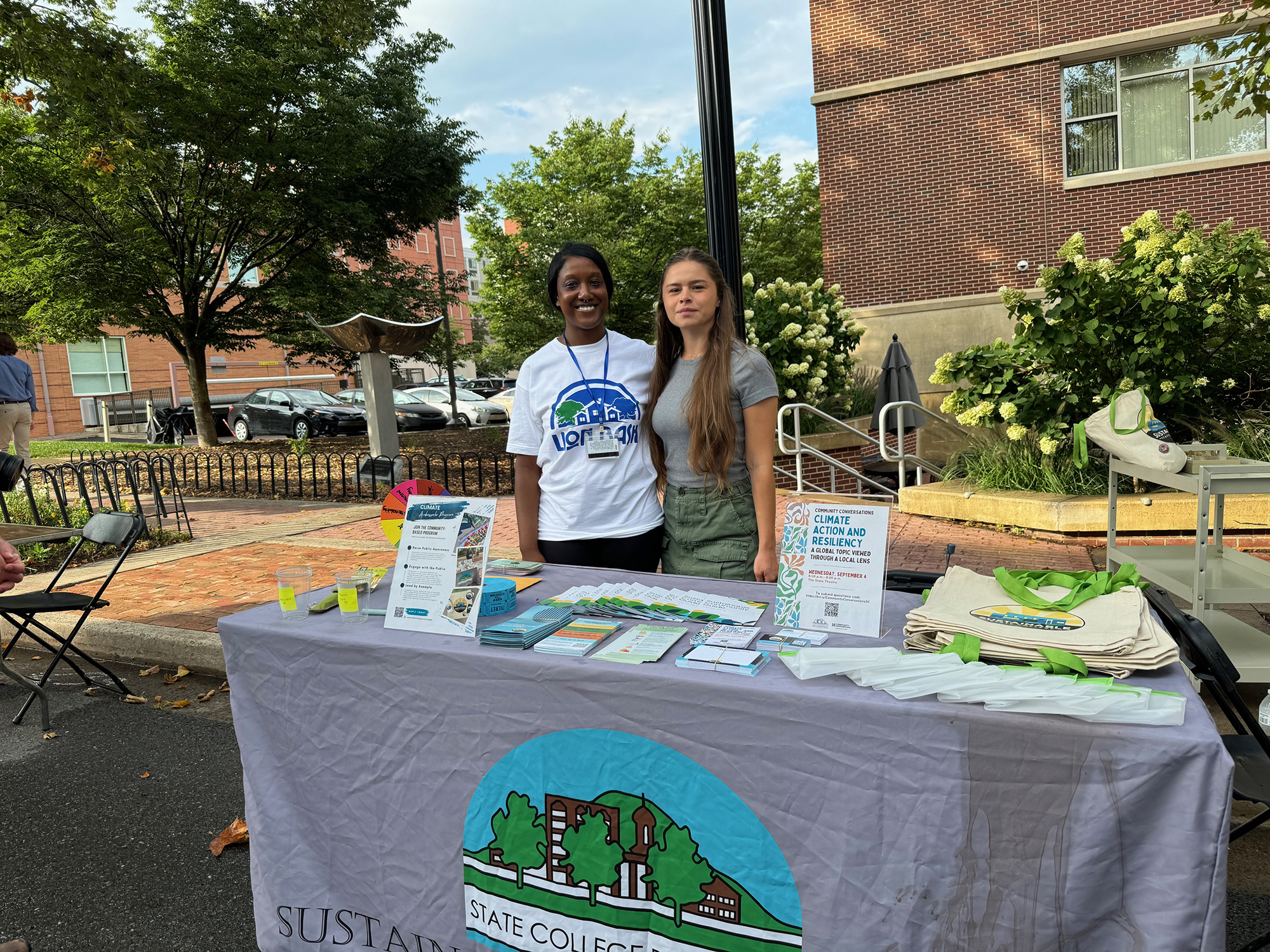 Jasmine Fields greets public at outdoor booth.