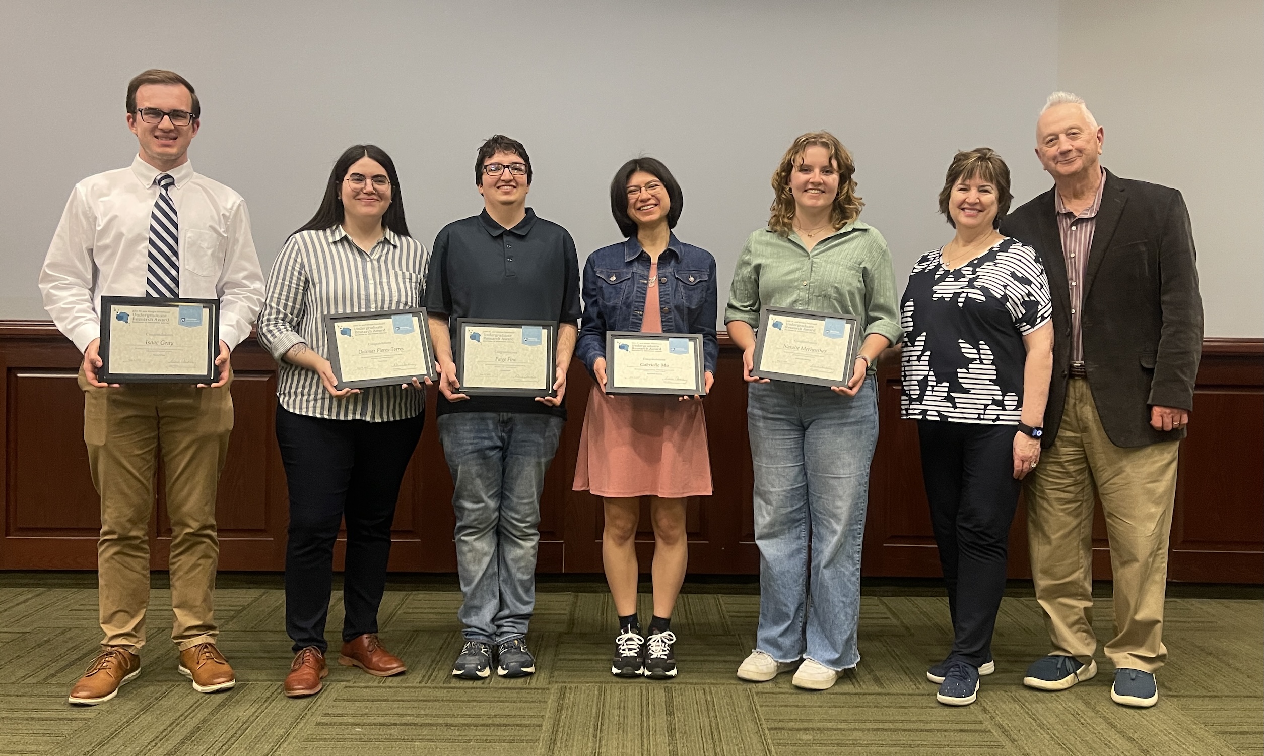 5 students holding awards standing next to John Sr. and Kimlyn Patishnock 