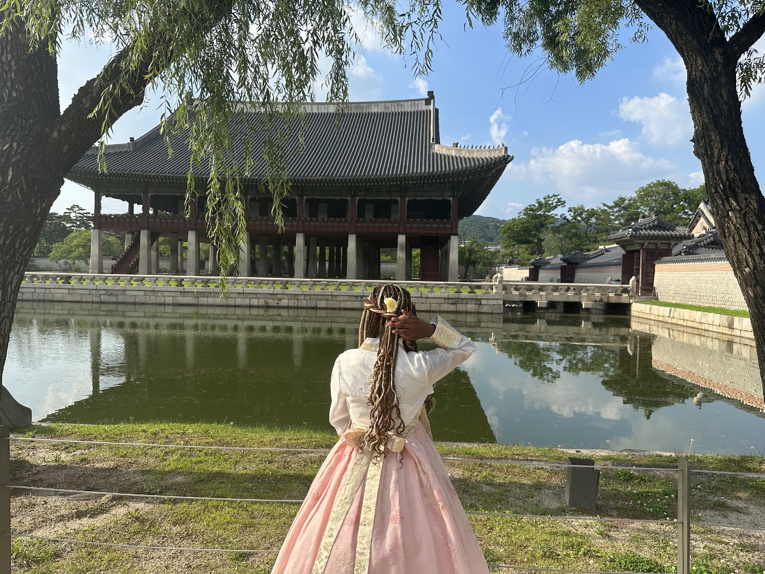 A woman standing in front of a pagoda