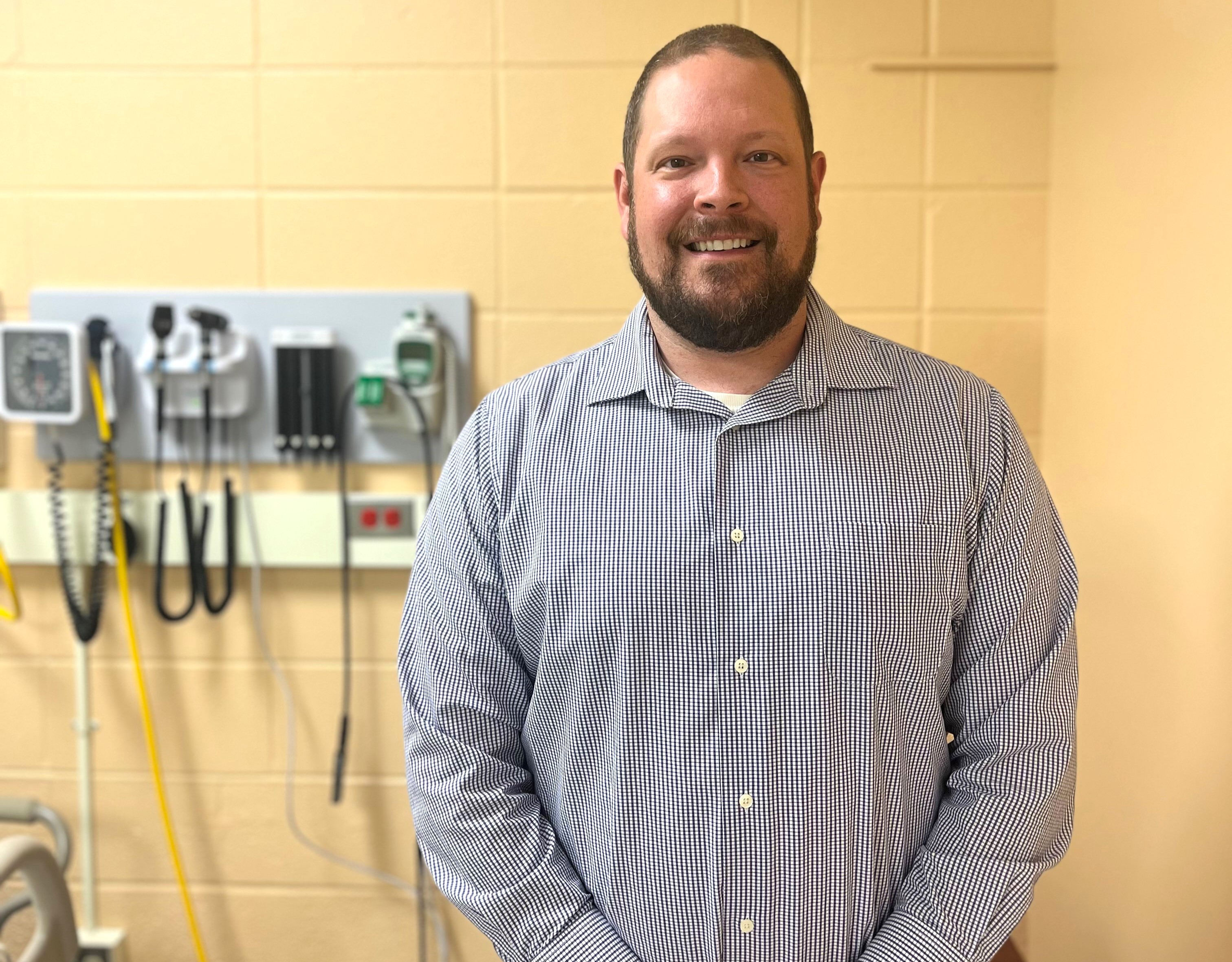 Daniel Eaton, a nursing instructor at Penn State Behrend, poses in a simulation lab.