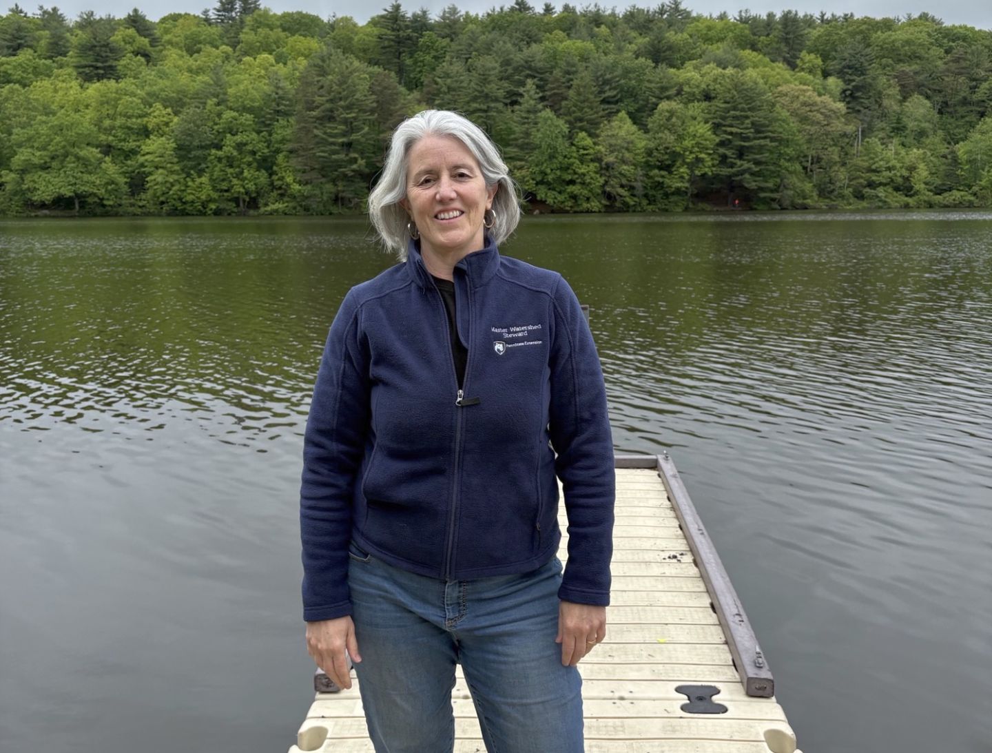 Master Watershed Steward Christine Boyle stands on a dock