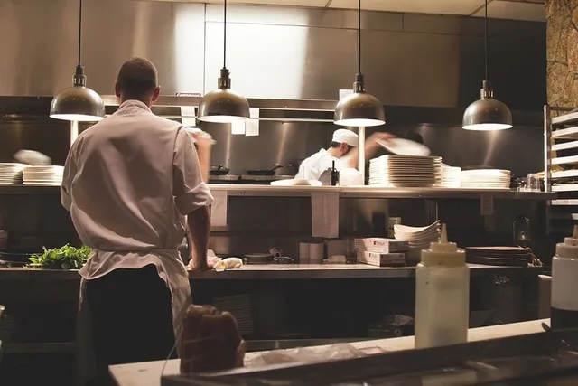 two people working in food prep area