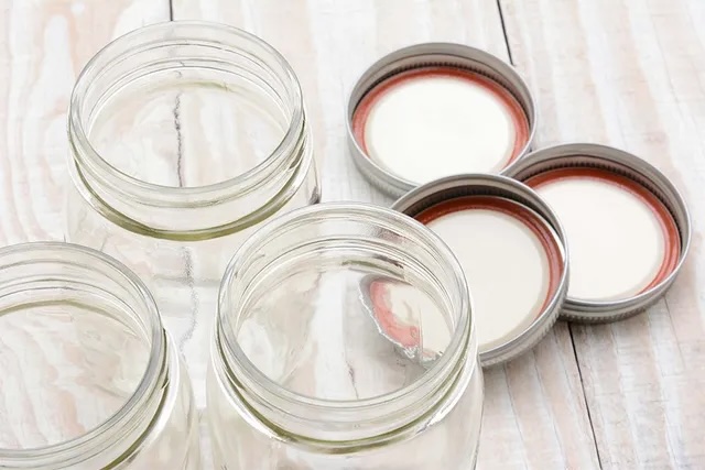 clean and empty glass canning lids and jars