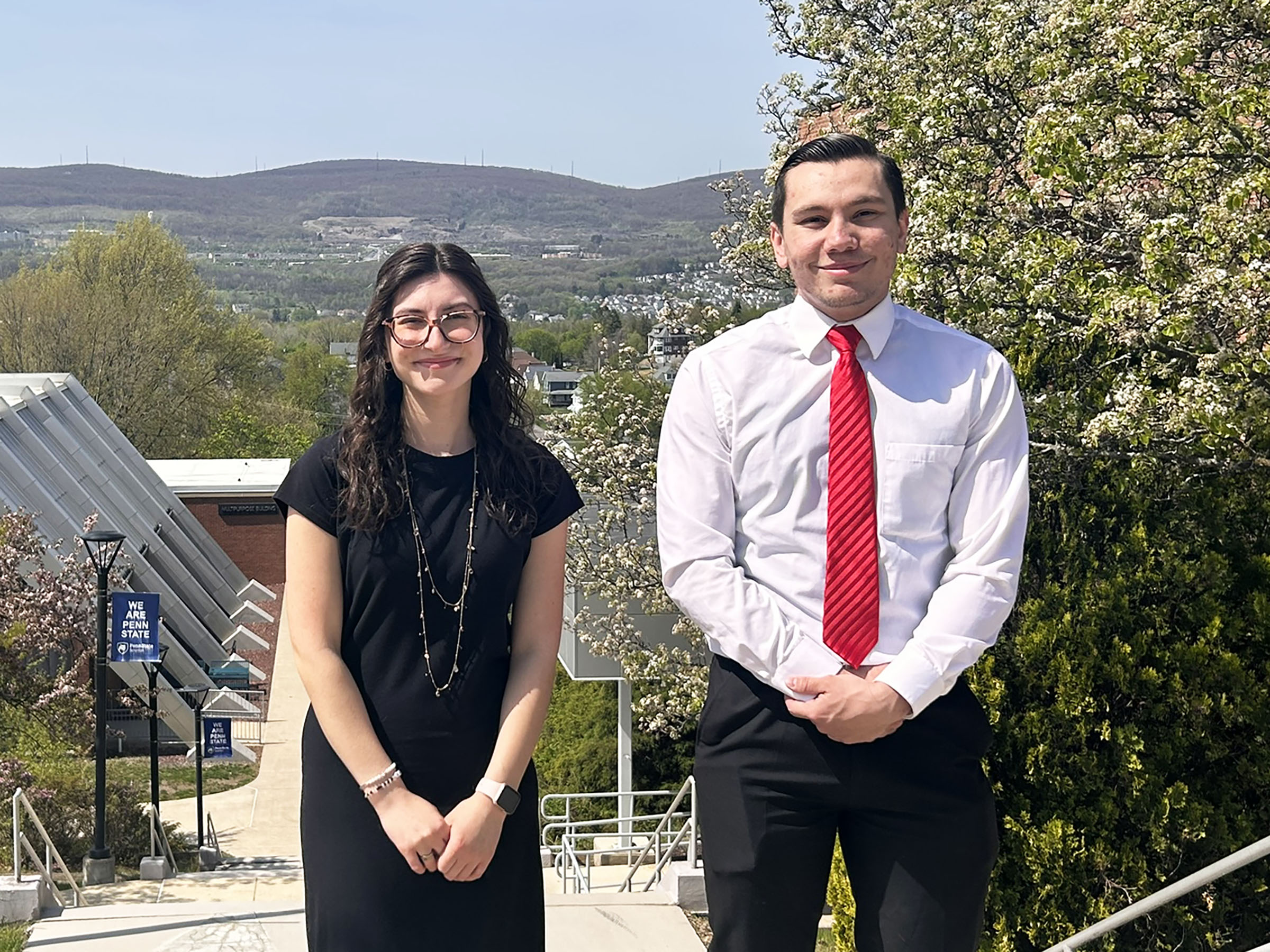 Zamarra and James pose outside for  photo at Penn State Scranton, with mountains in the background