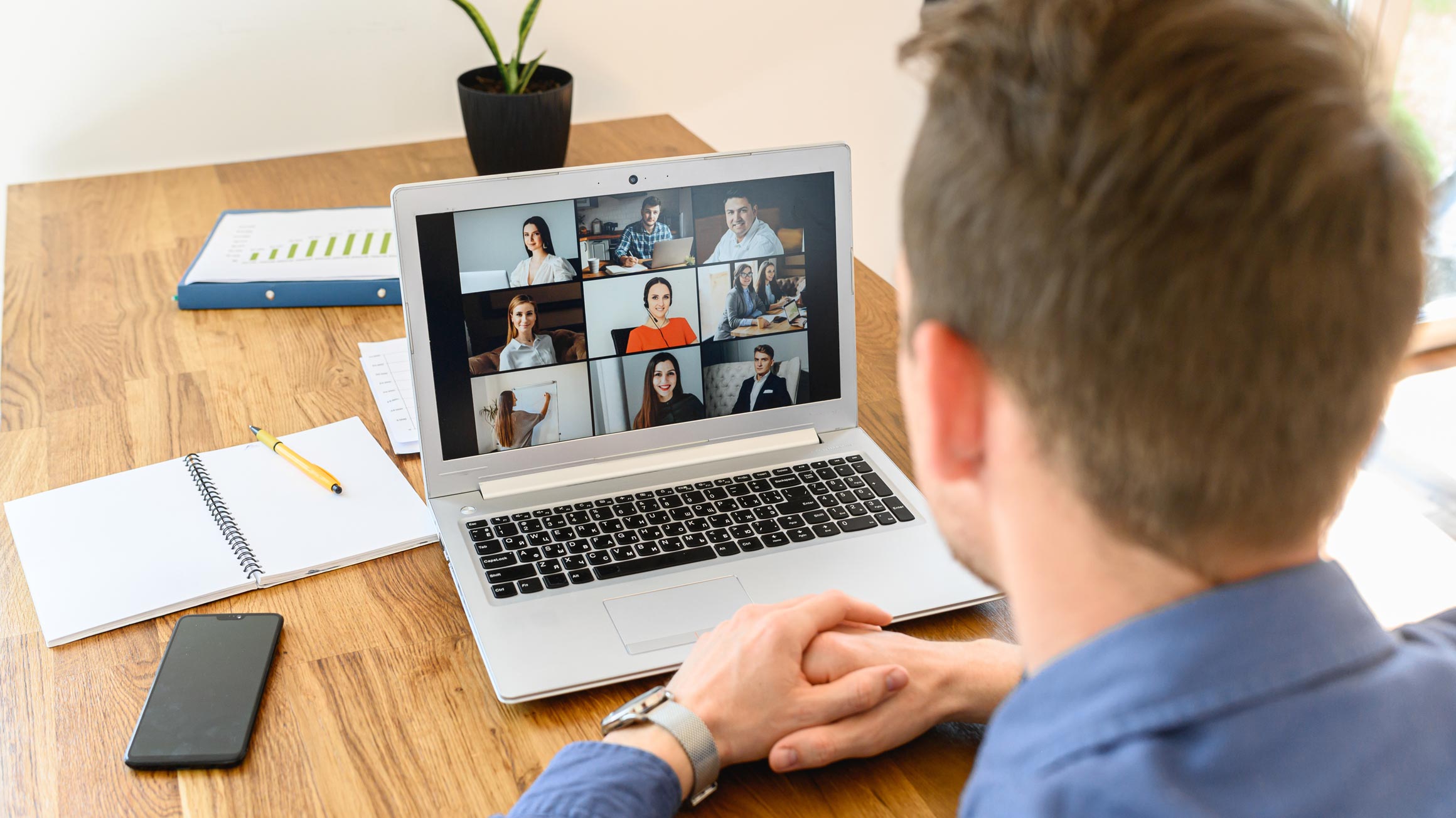 A man looking at a computer screen during an online meeting.