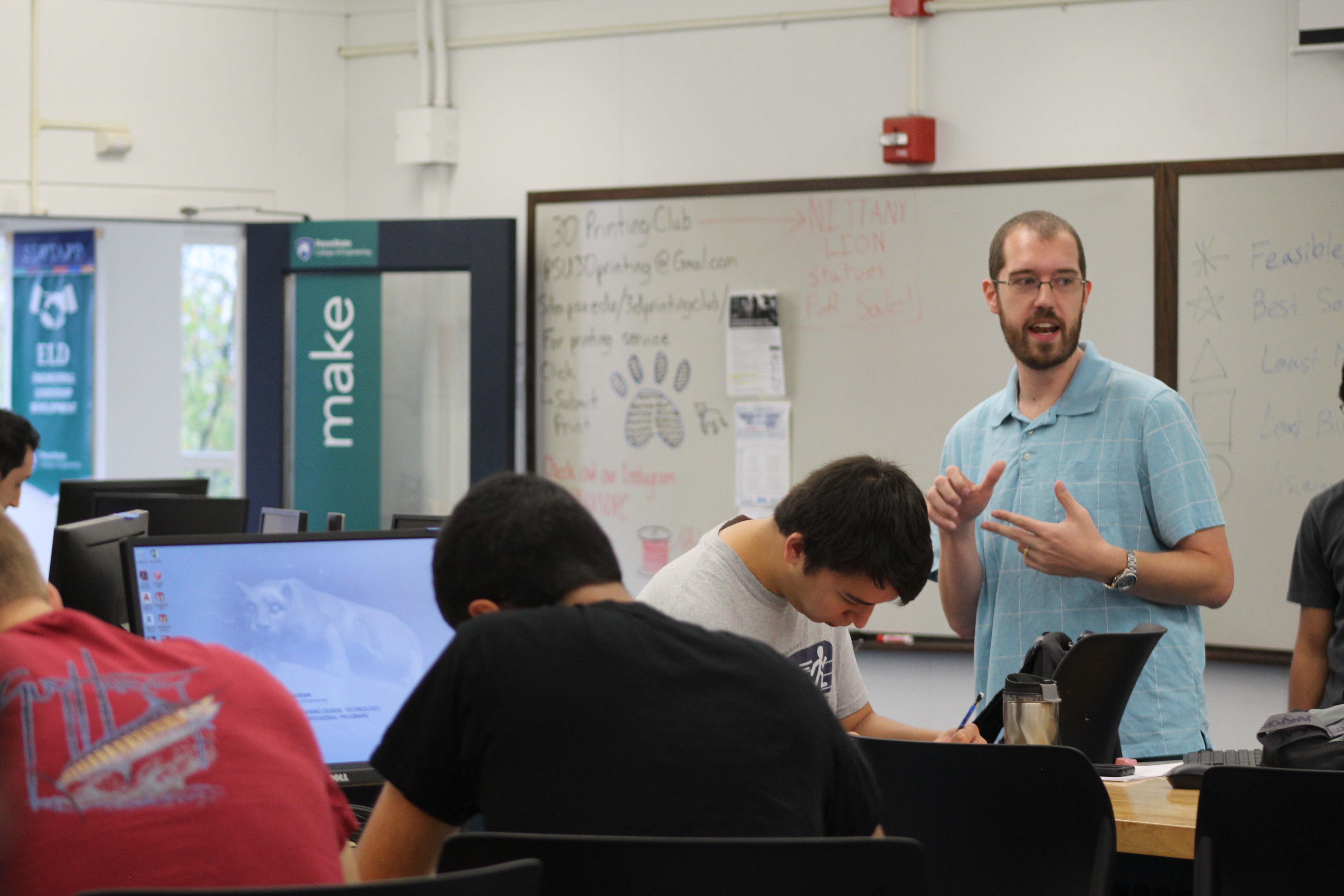 Professor in front of the class talking to students 