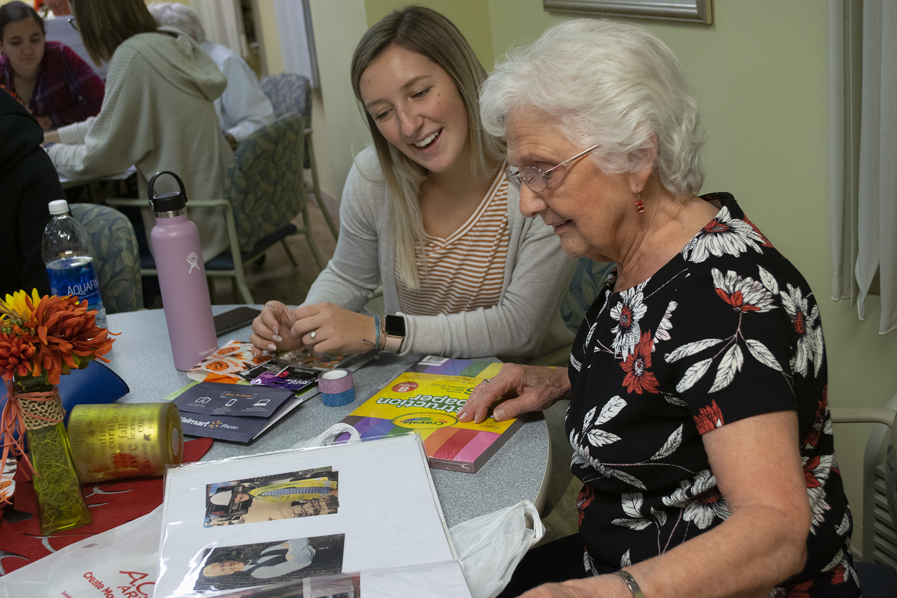 younger woman sitting with older woman