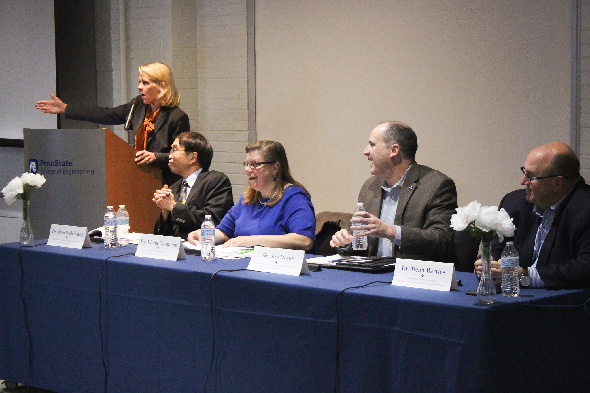 A group of mechanical engineers speak on a panel.