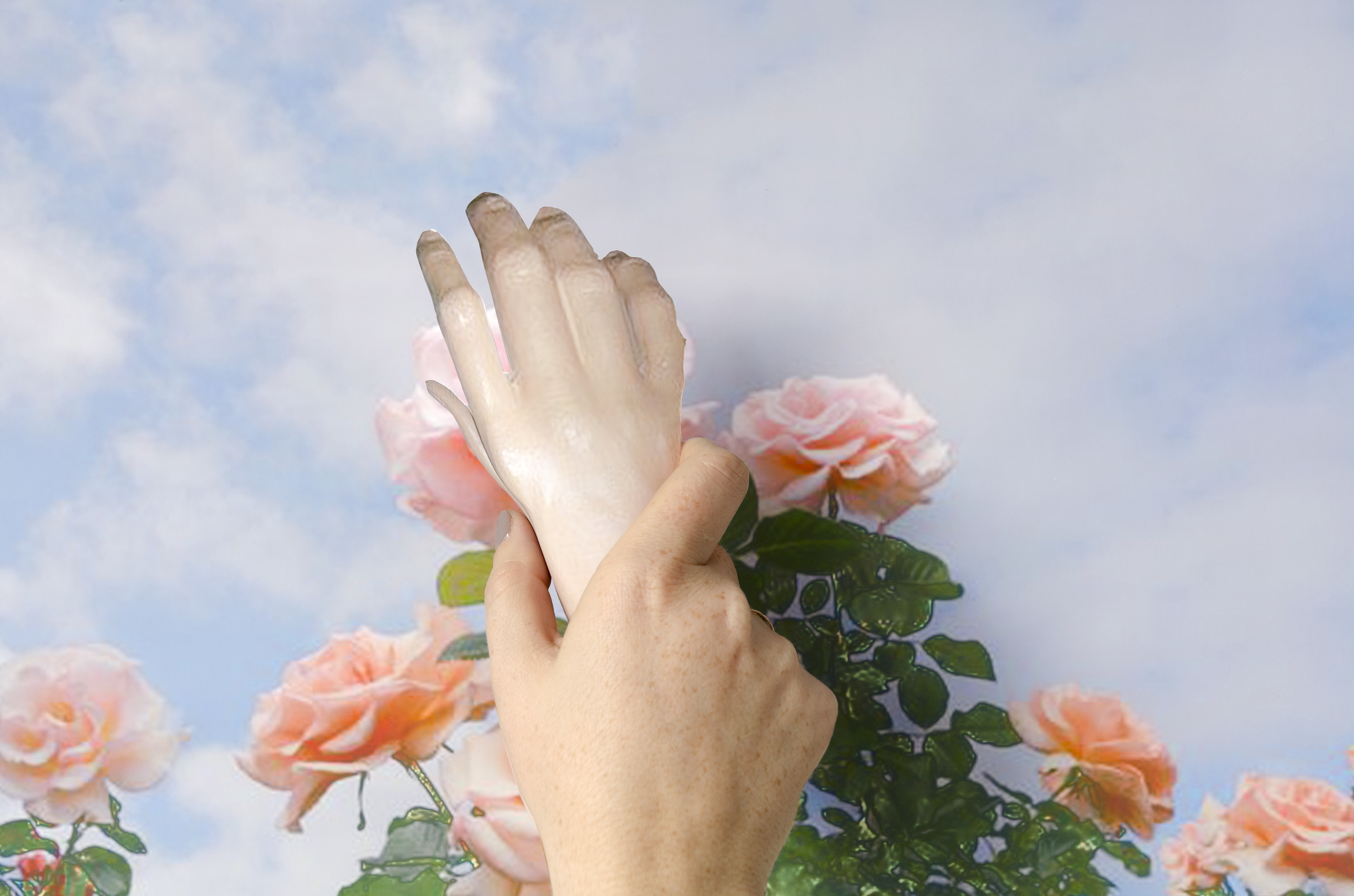 hand holding foot on top of flowers