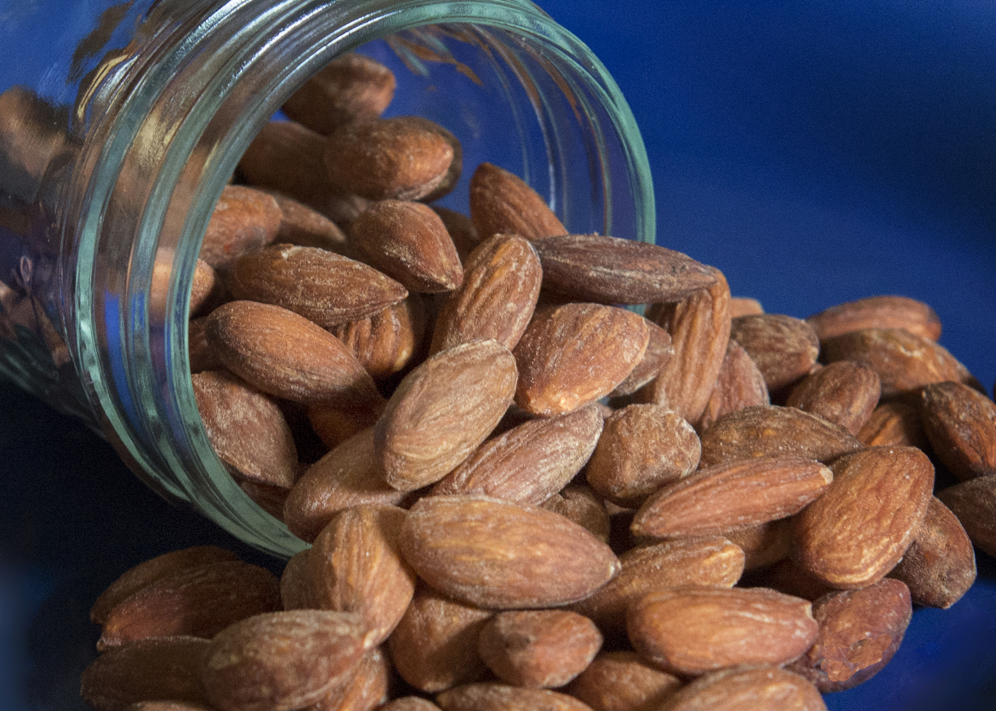 Almonds spilling out of a jar