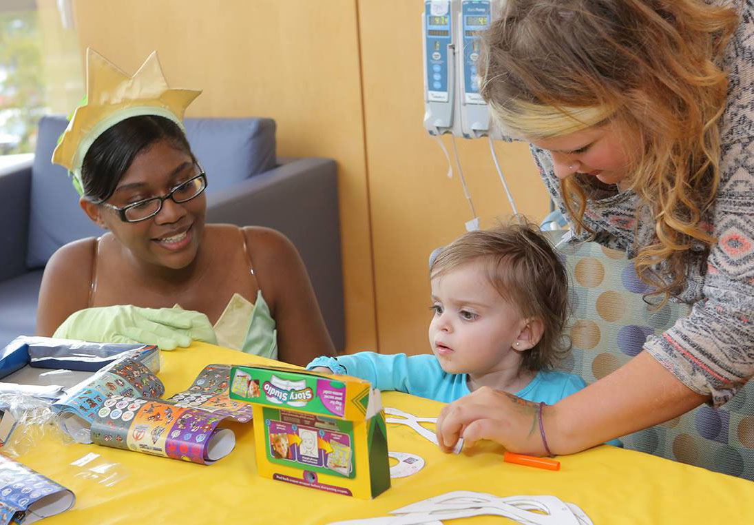 Amina Grant makes crafts with children at Hershey medical center