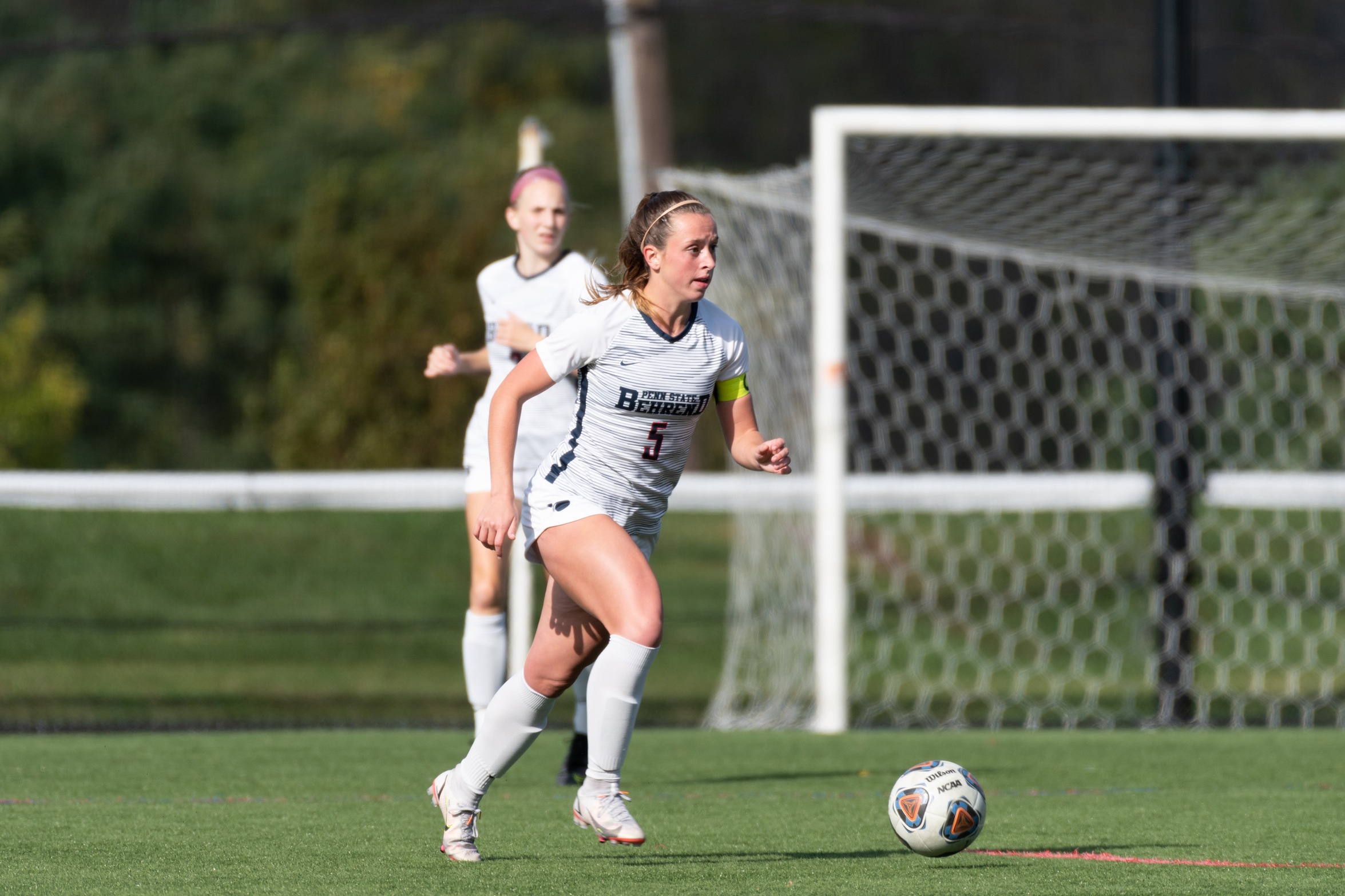 A Penn State Behrend soccer player prepares to kick the ball.