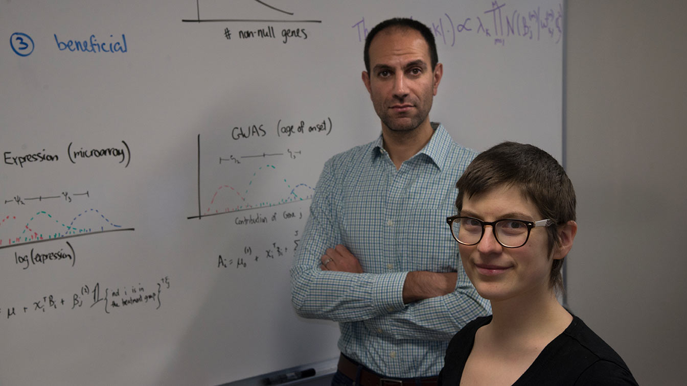 Ben Shaby and Daisy Philtron in front of whiteboard with equations