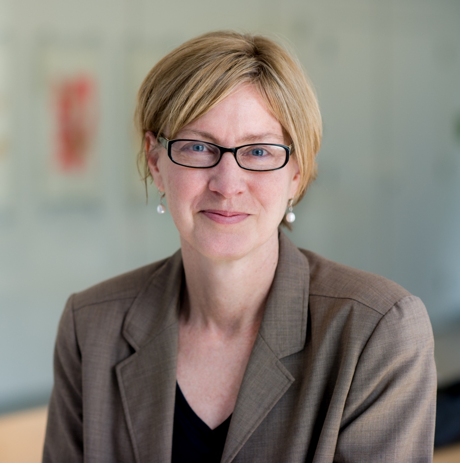 Susan Short headshot in tan sweater and glasses