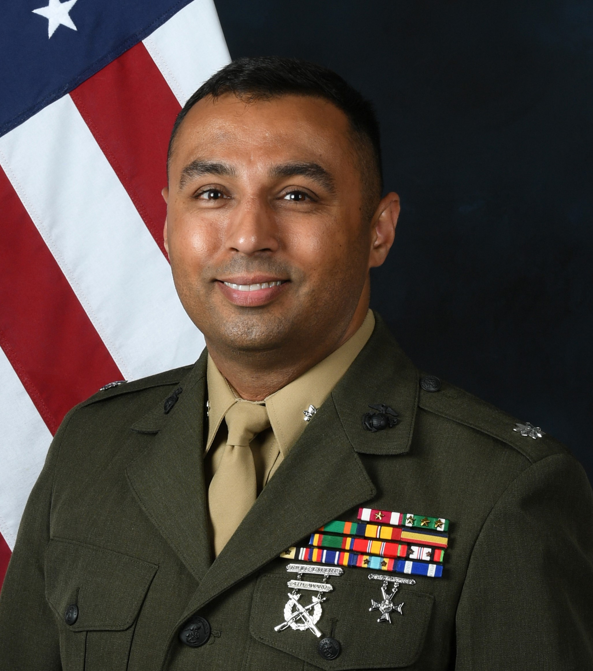 Headshot photo of Lt. Col. Tom Chhabra in Marine Corps uniform with the American flag in the background.